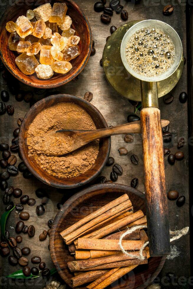 Coffee background. Welded coffee in a Turkish with sugar, cinnamon and coffee beans. photo