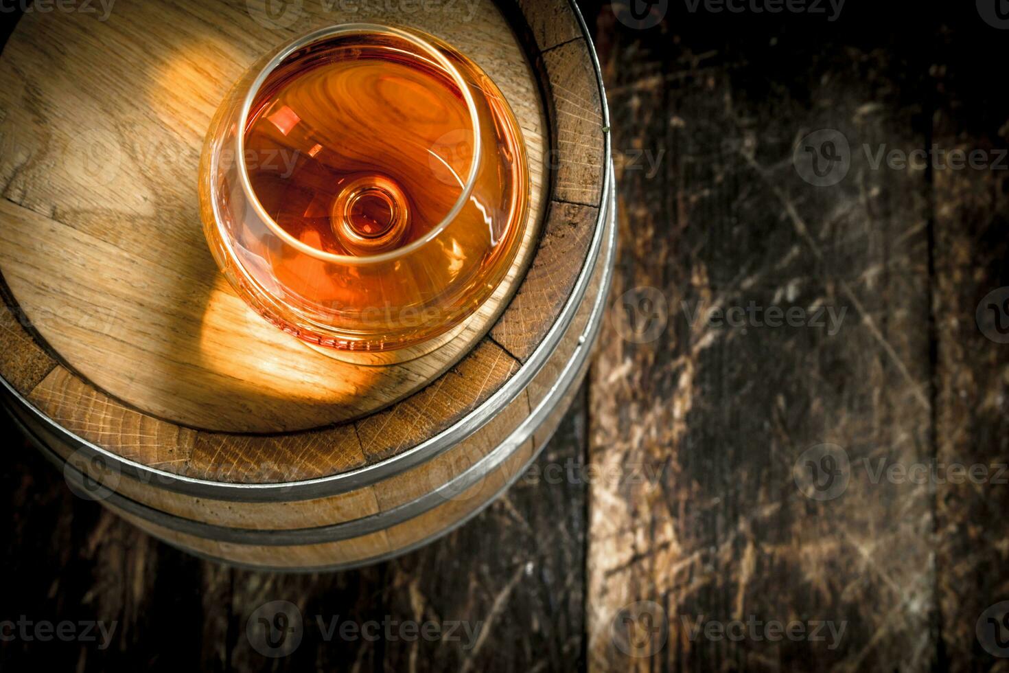 barrel with a glass of cognac. photo