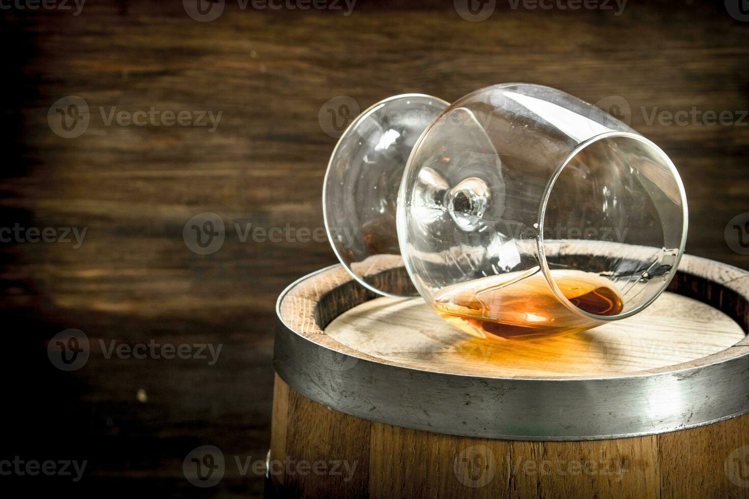 barrel with a glass of cognac. photo