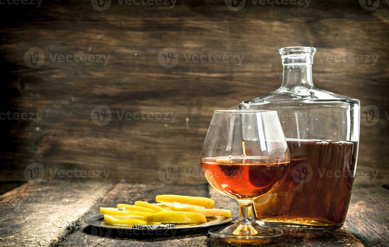 Cognac with lemon wedges. photo
