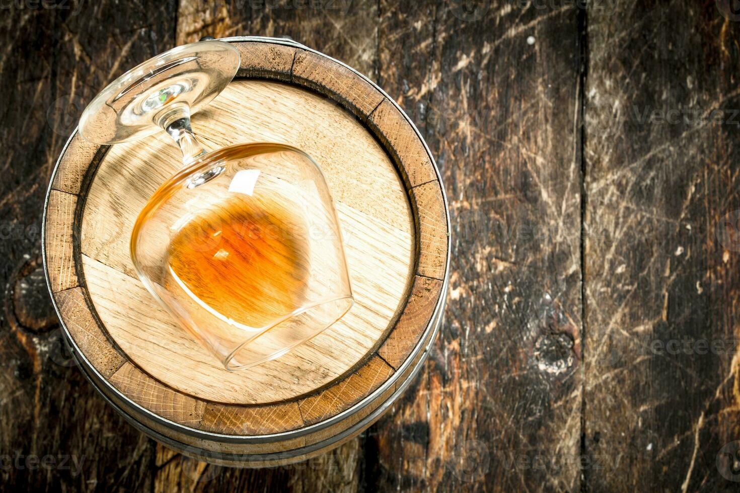 barrel with a glass of cognac. photo