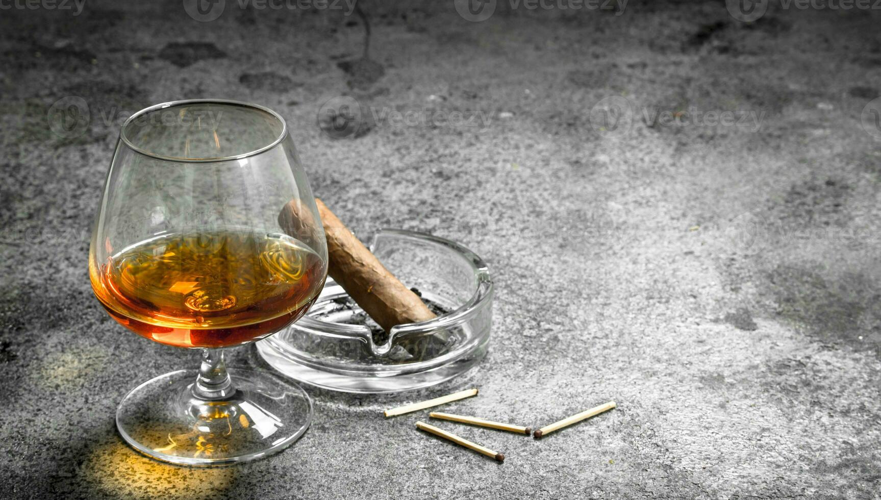 glass of cognac with a cigar. photo