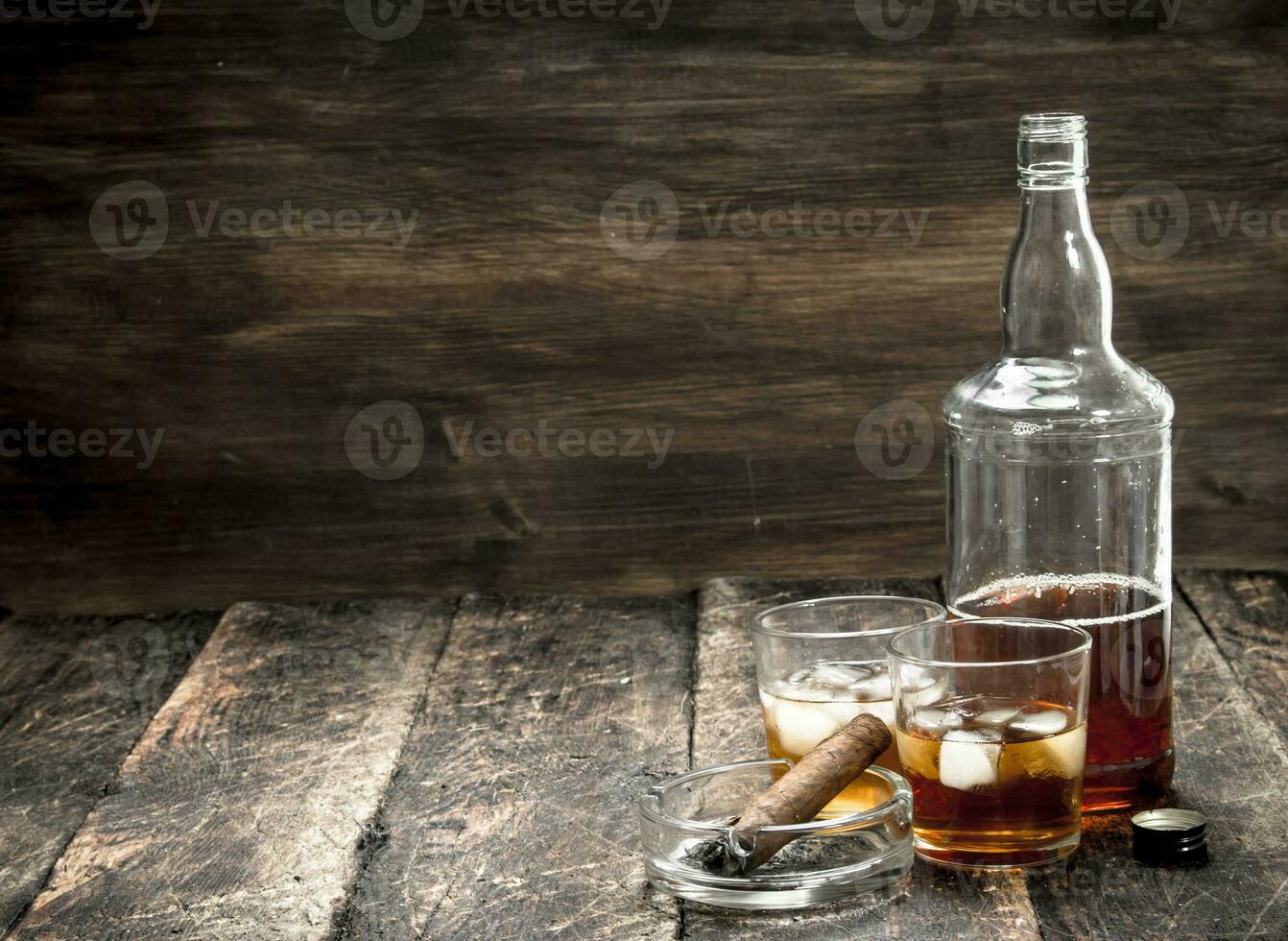 Whiskey with ice and a cigar. photo