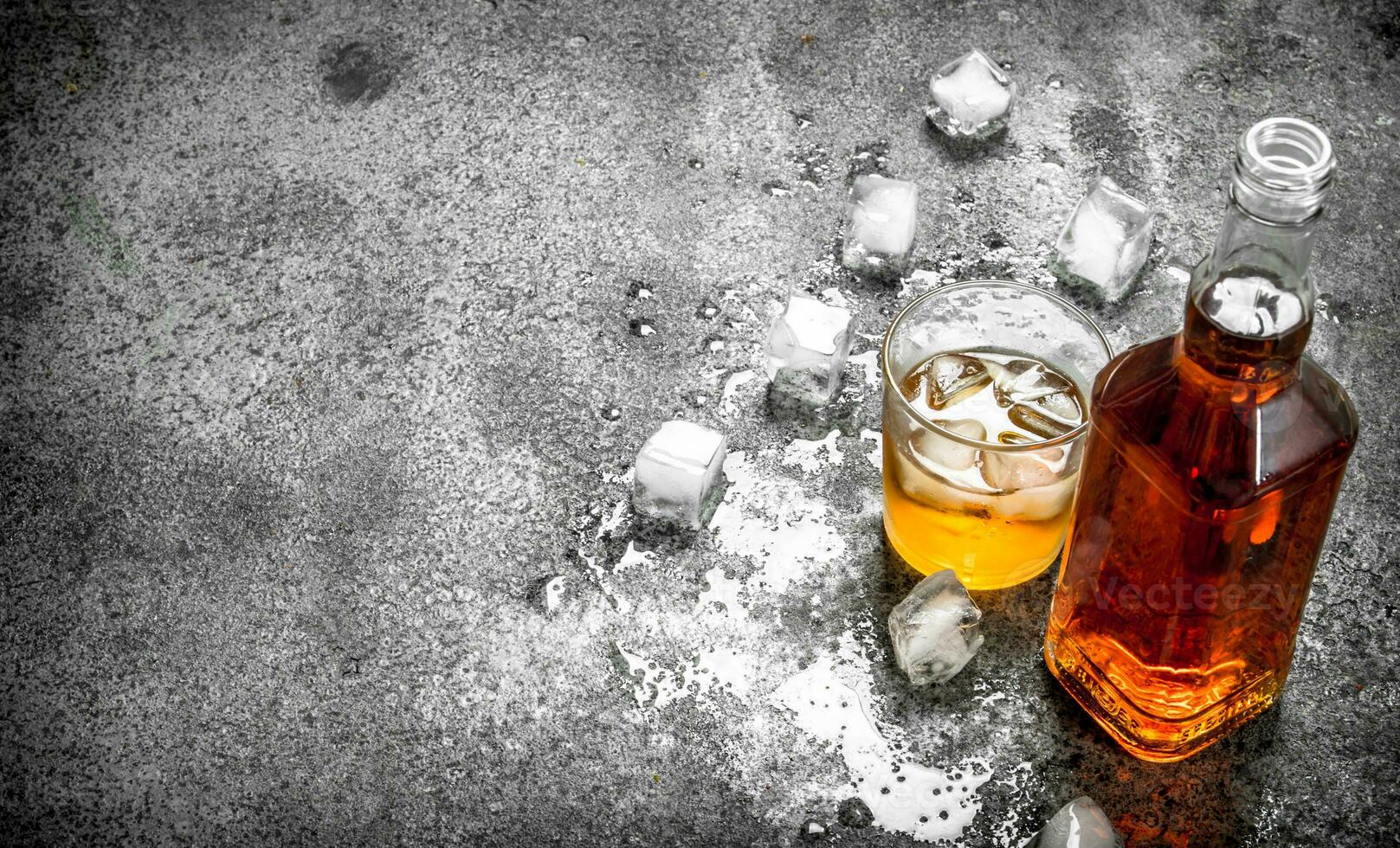 glass of whiskey with ice cubes. photo