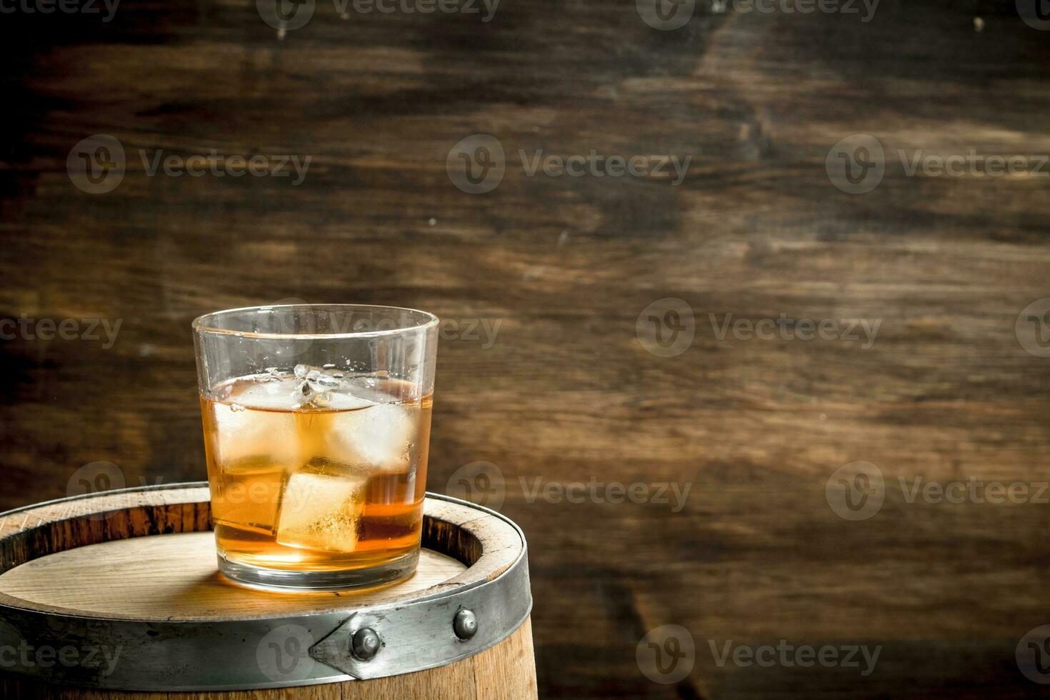 glass of Scotch whiskey with a barrel. photo