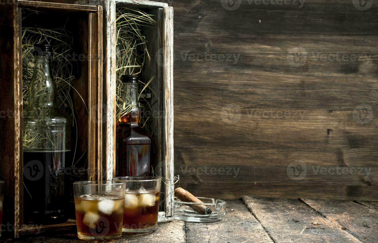 Bottles with whiskey in old boxes. photo