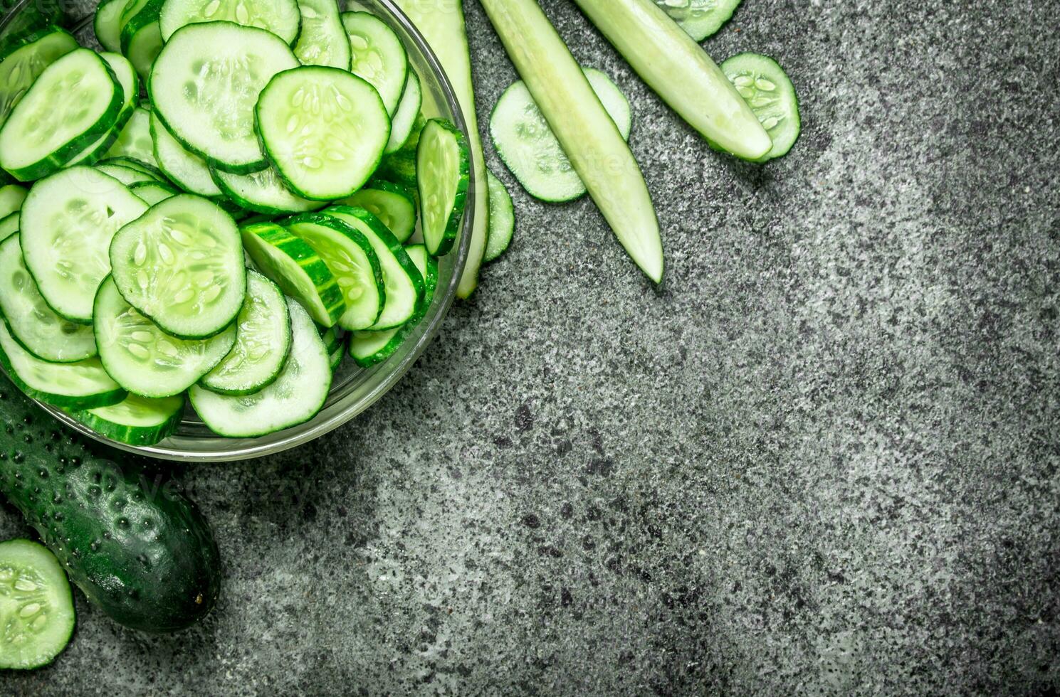 Slices of fresh cucumbers in a bowl. photo