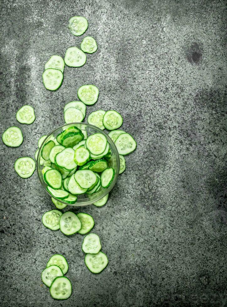 Slices of fresh cucumbers in a bowl. photo