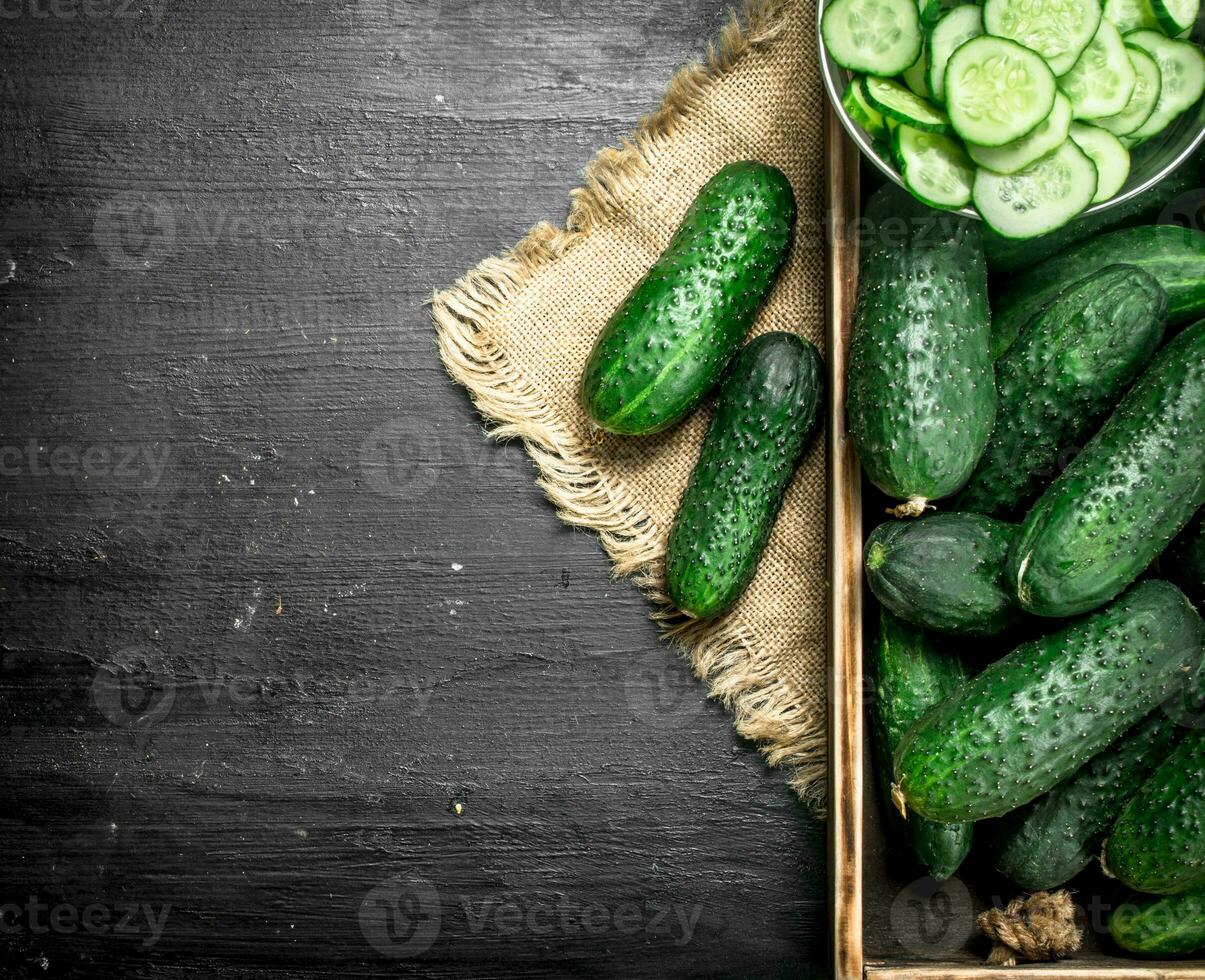 Fresh cucumbers in a wooden tray. photo