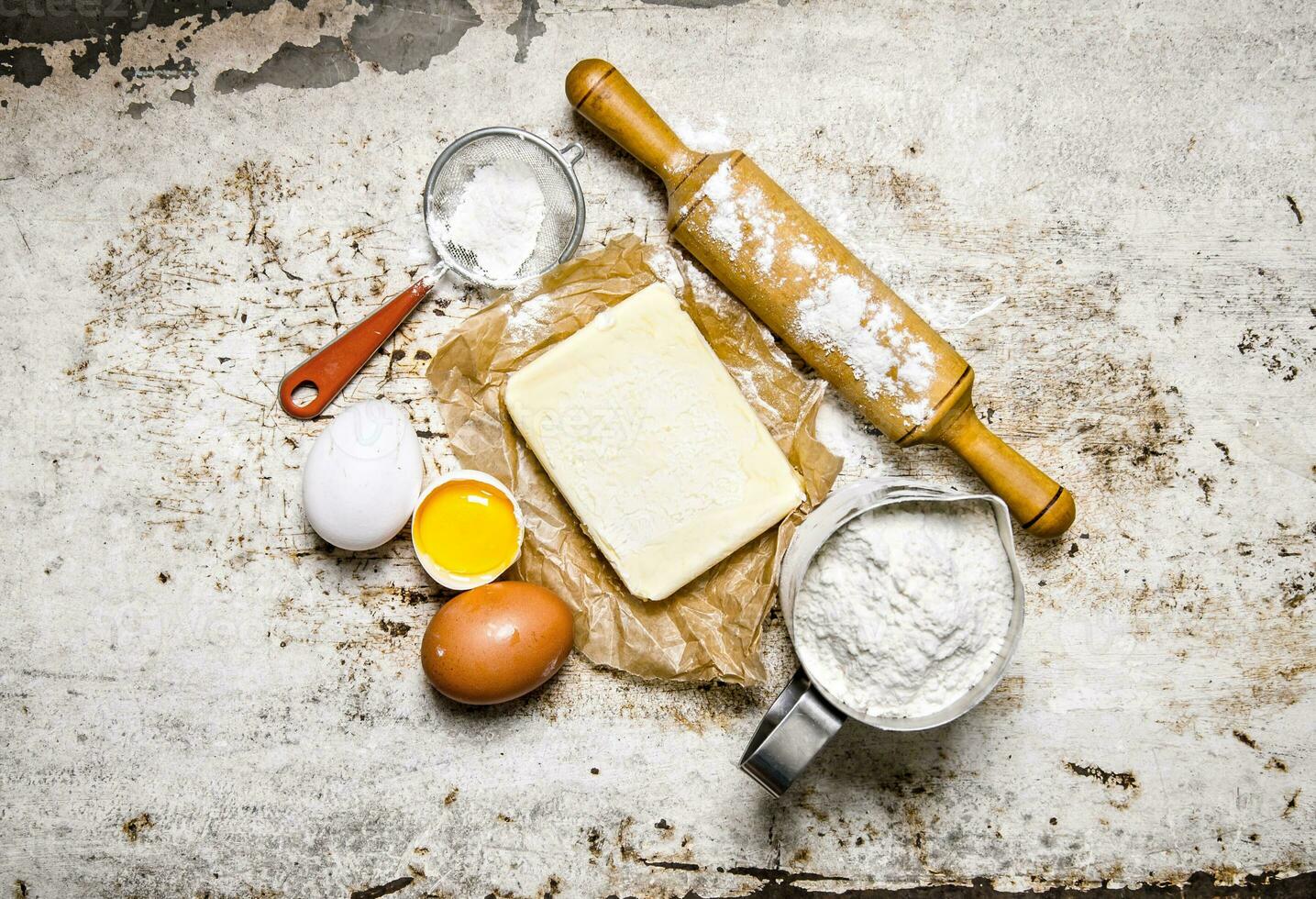 Preparation of the dough. Ingredients for the dough - Flour, eggs, butter with a rolling pin. photo