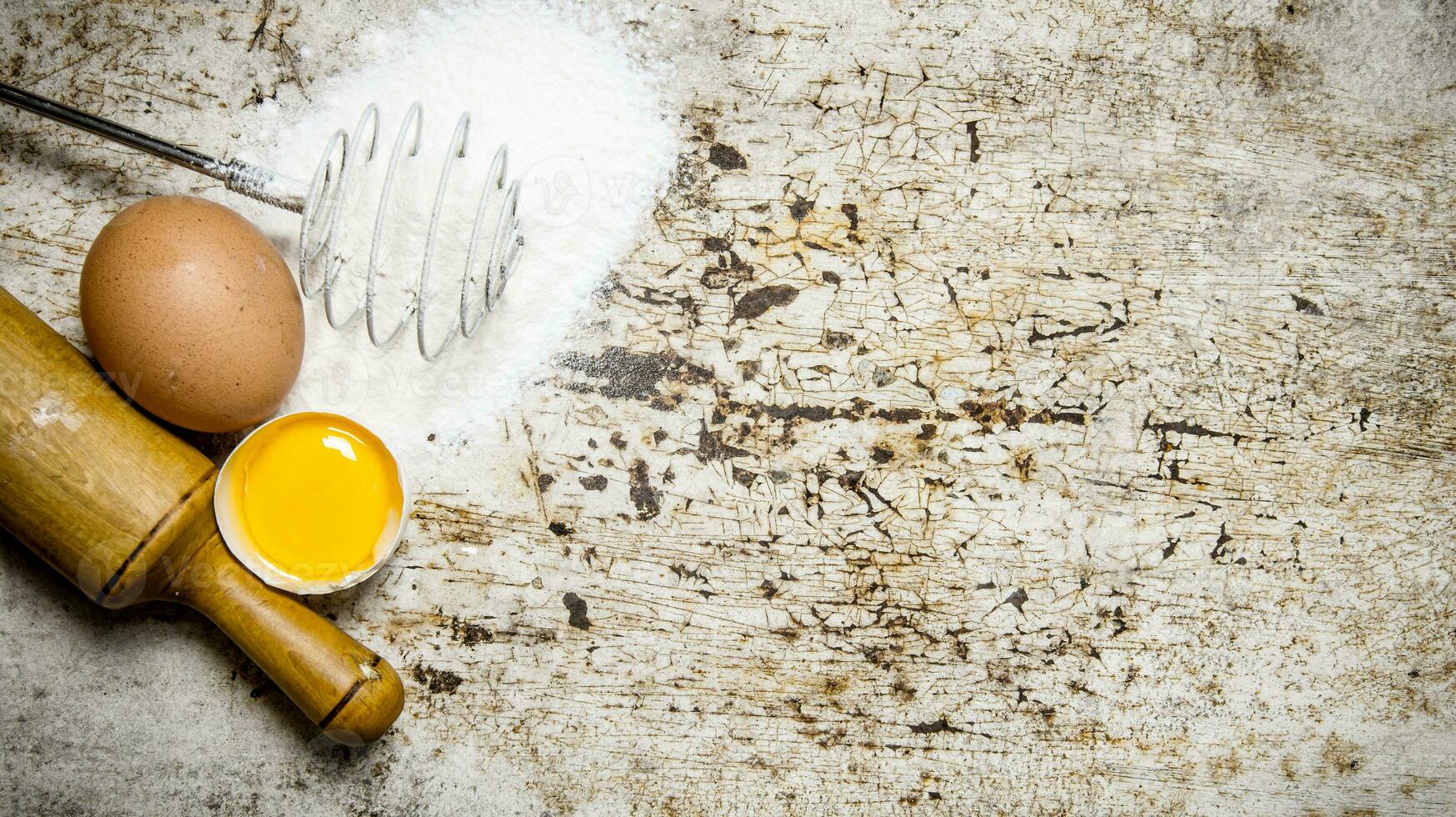 Preparation of the dough. Ingredients for the dough - Flour , eggs and rolling pin. photo