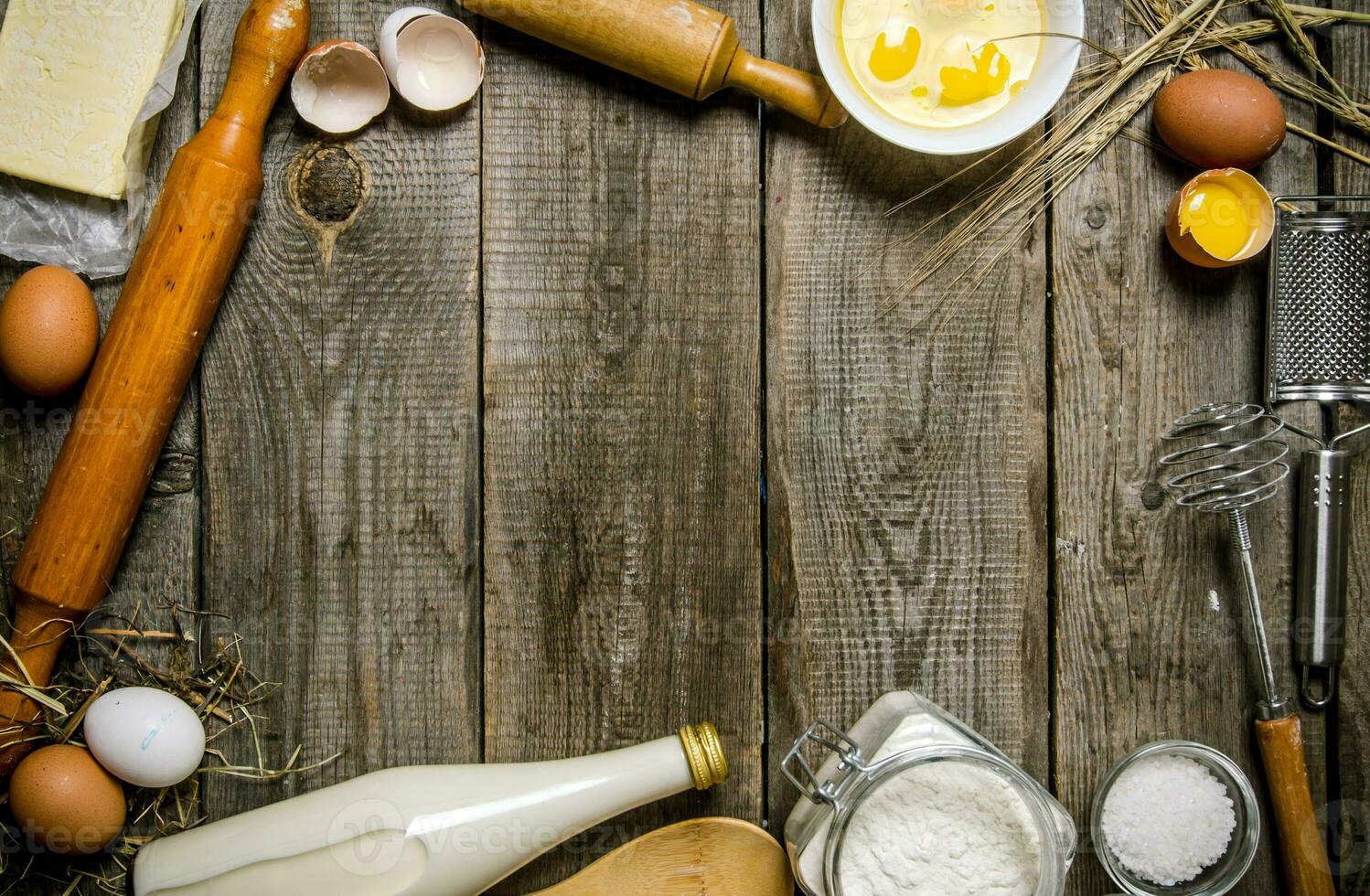 Preparation of the dough. Ingredients for the dough - milk, flour, eggs and different tools . photo