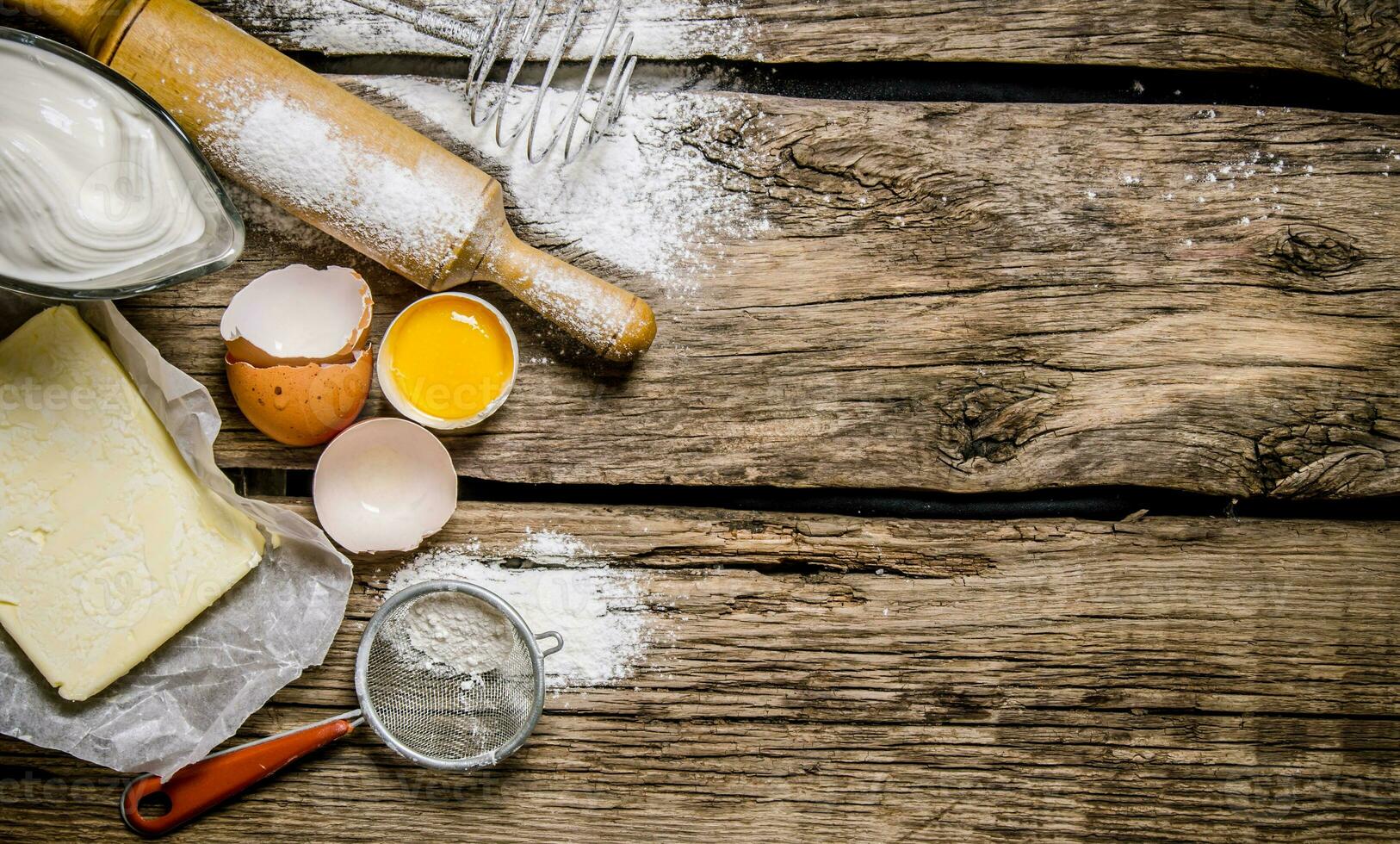 Preparation of the dough. Ingredients for the dough - egg, flour, butter with a rolling pin . photo