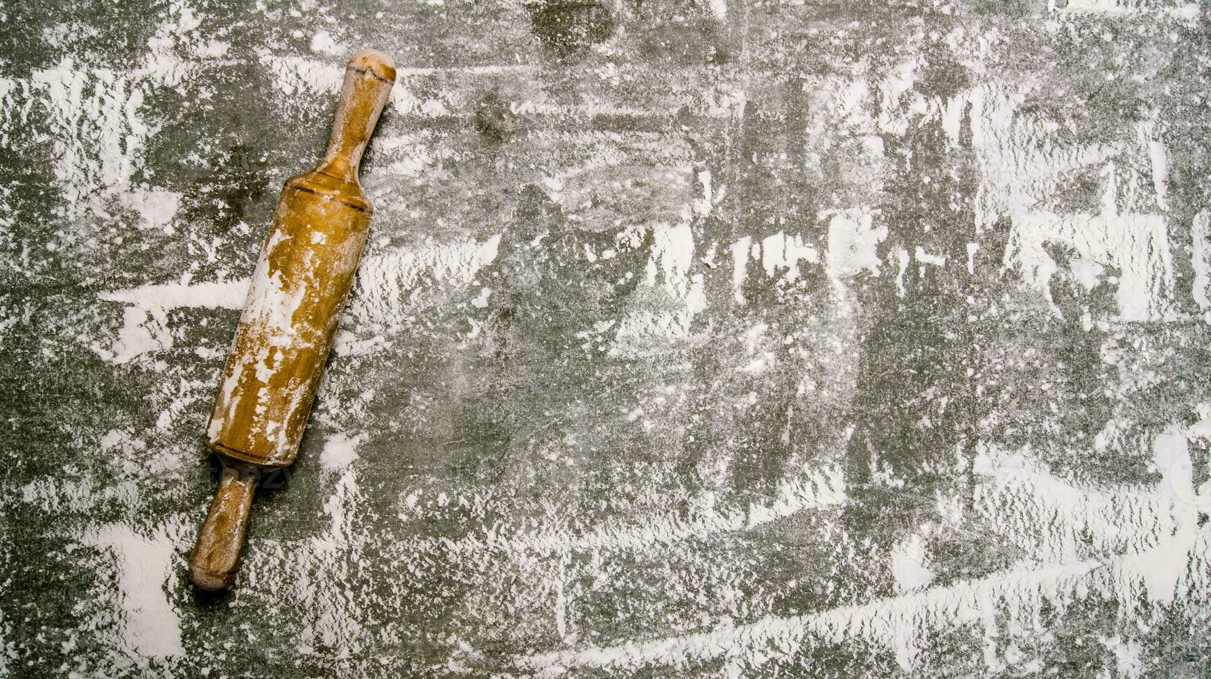 Baking background with a rolling pin with flour. photo