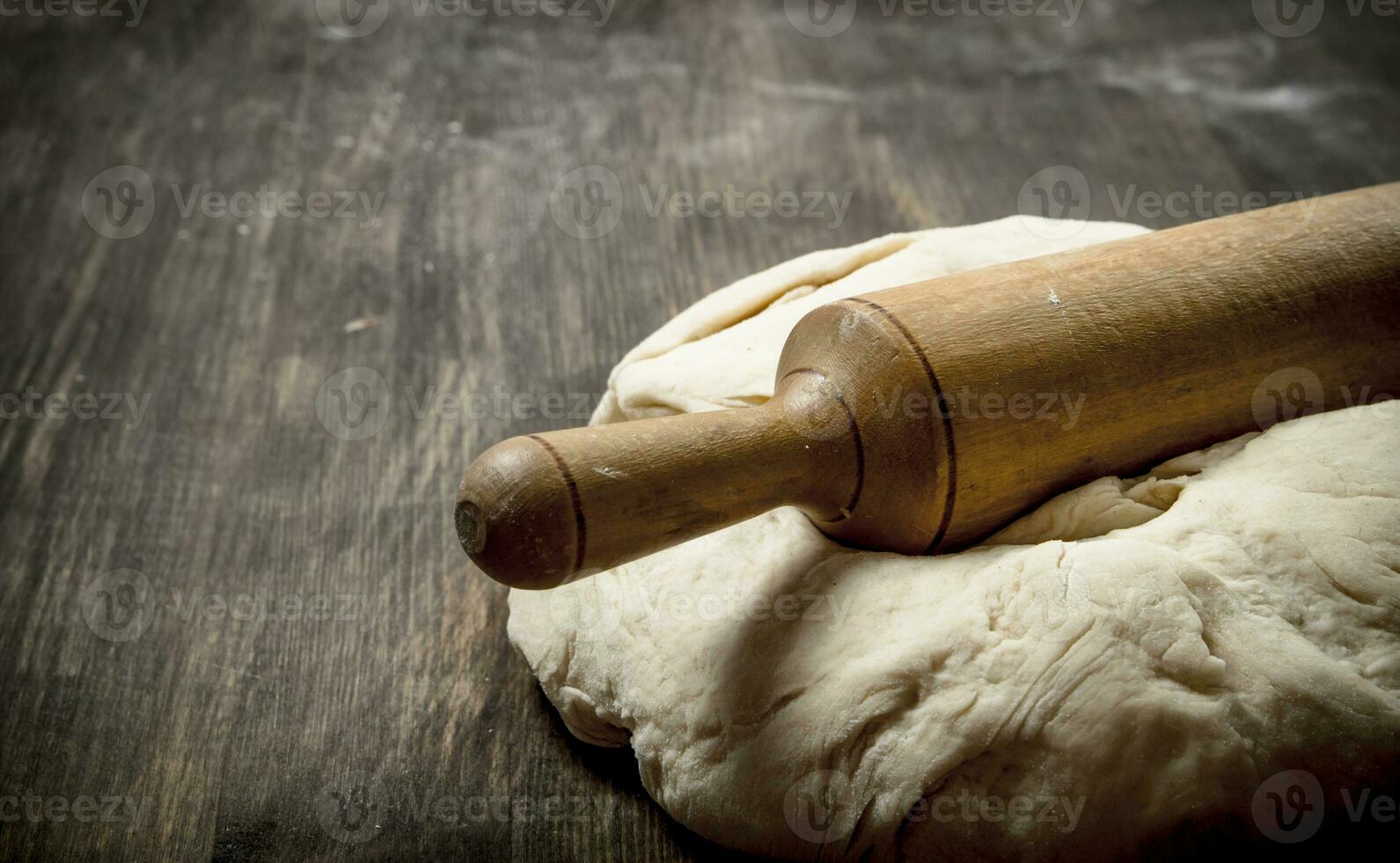 Fresh dough with a rolling pin. photo