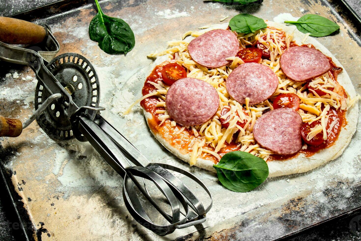 Unprepared pizza with ingredients. photo