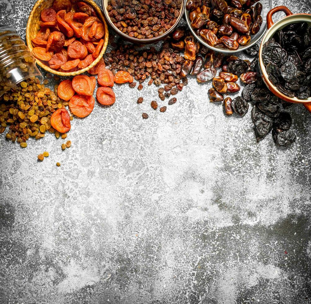 Various dried fruit in bowls. photo