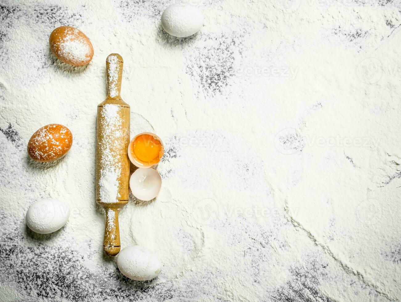 Rolling pin with fresh eggs photo