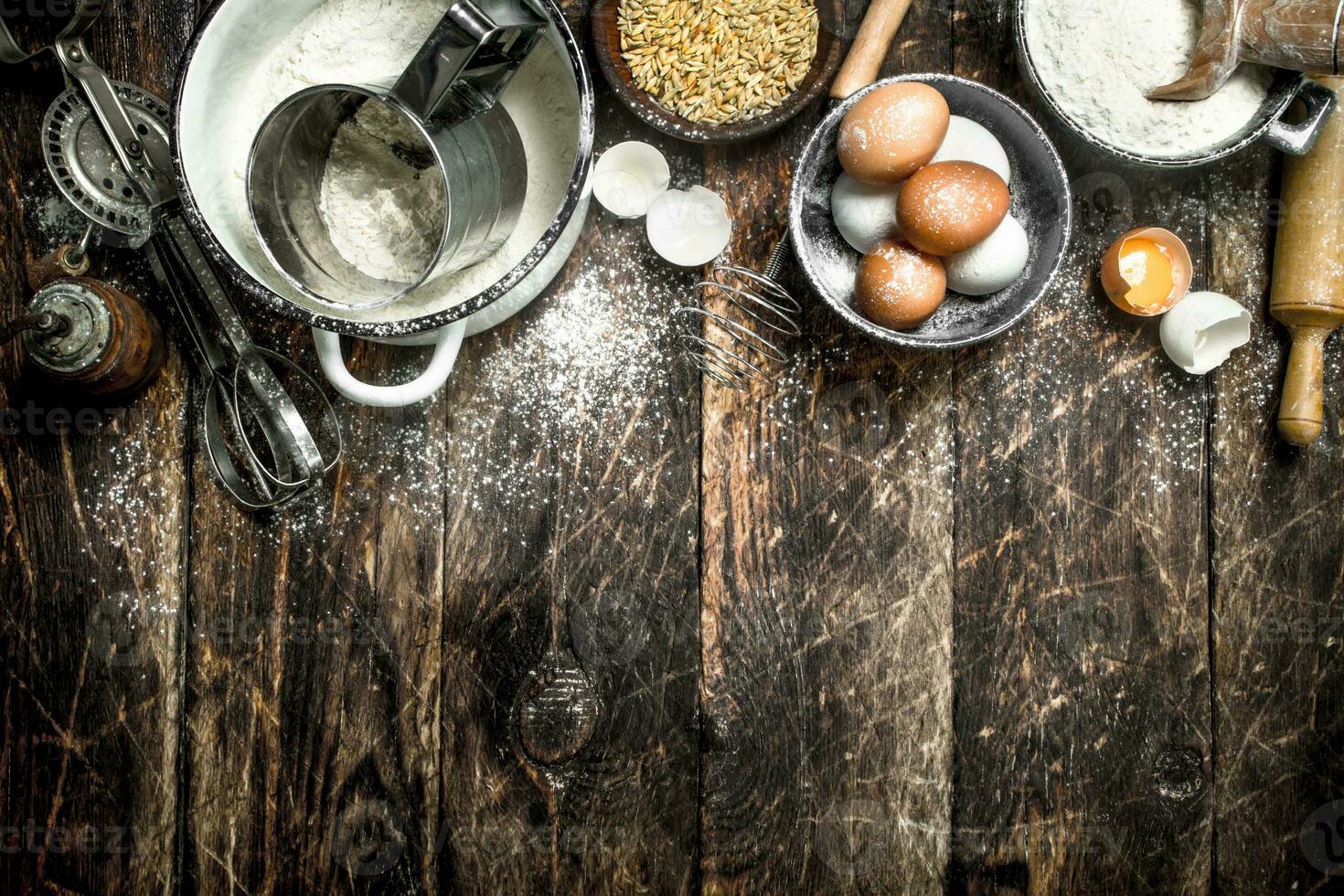 Dough background. Flour with wheat grains and fresh eggs. photo