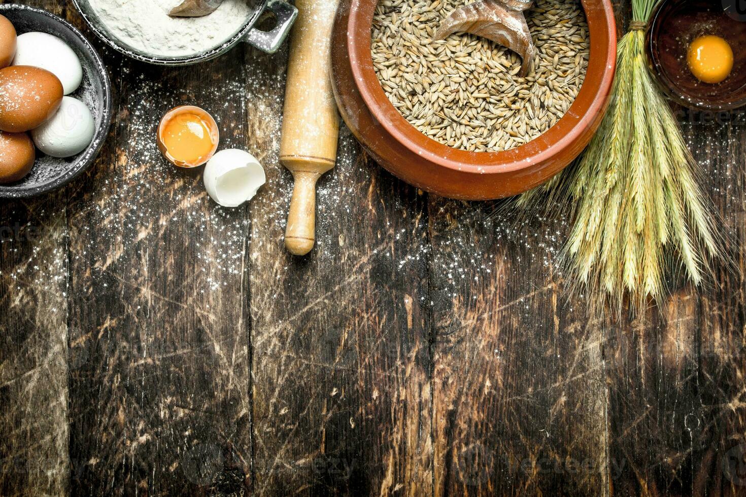 Dough background. Flour with wheat grains and fresh eggs. photo