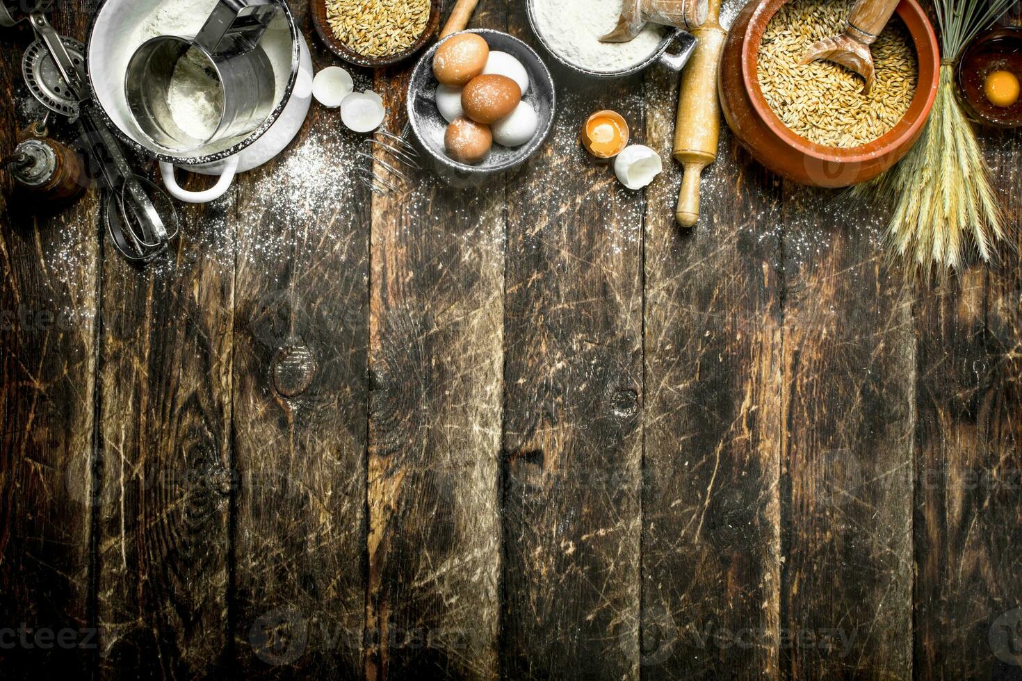 Dough background. Flour with wheat grains and fresh eggs. photo