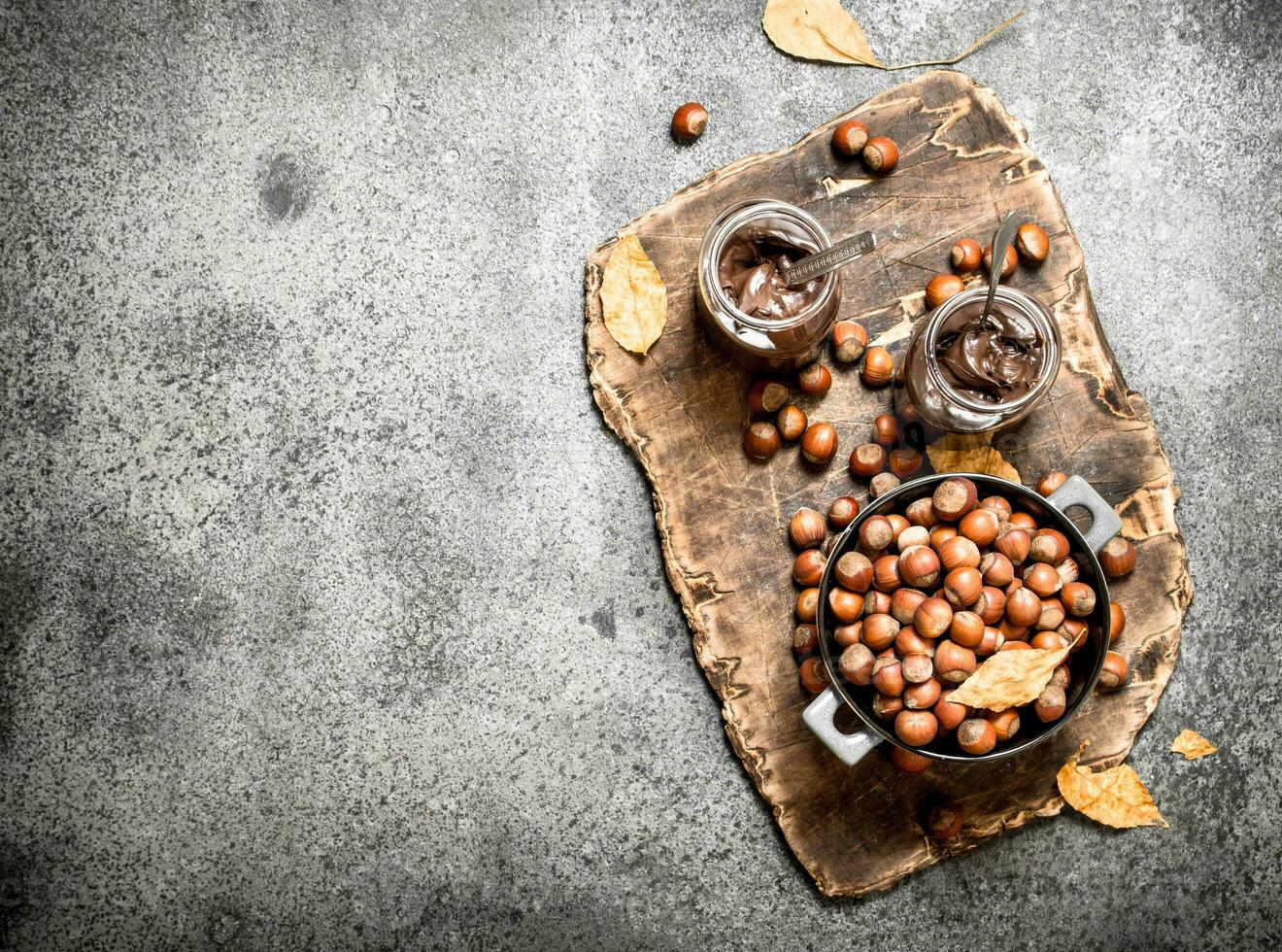nut butter from hazelnuts and chocolate. On rustic background. photo