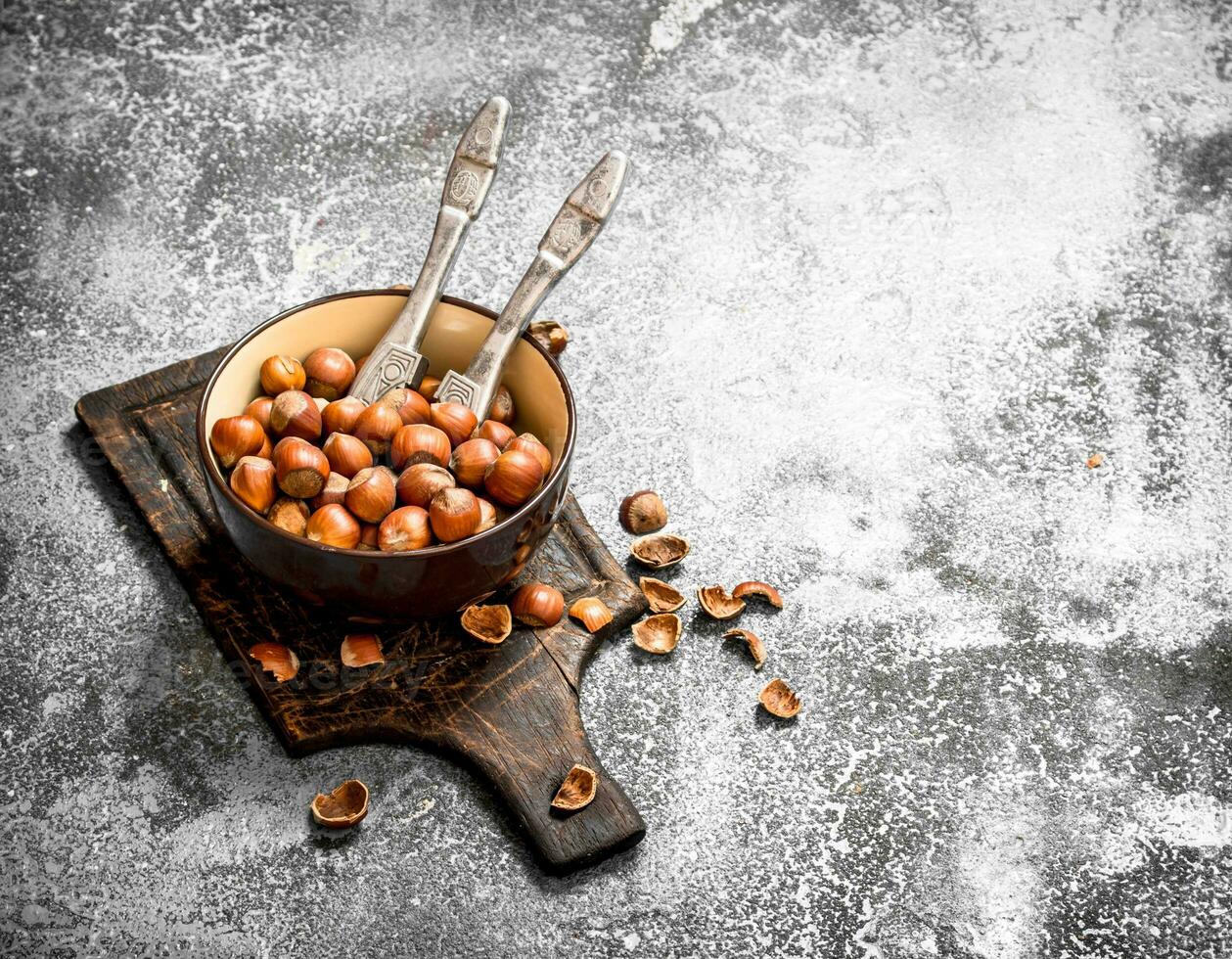 Hazelnuts in a bowl with a Nutcracker. photo
