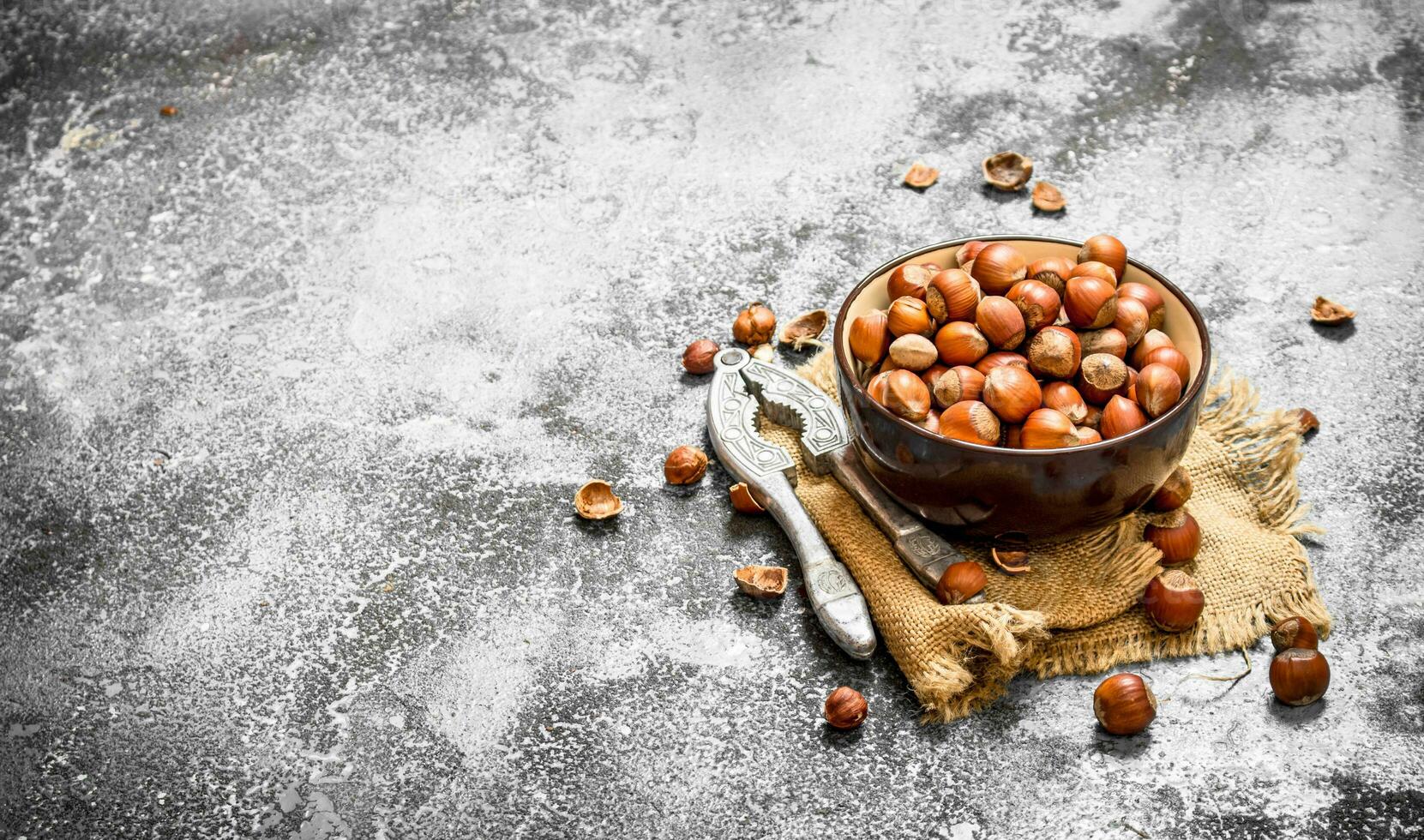 Hazelnuts in a bowl with a Nutcracker. photo