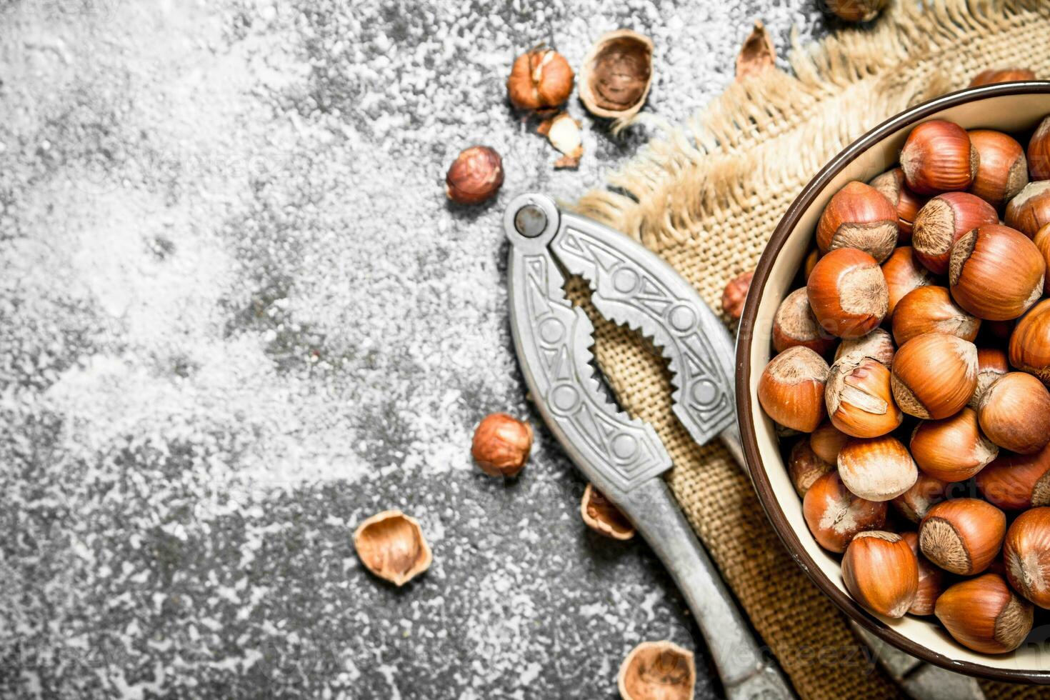 Hazelnuts in a bowl with a Nutcracker. photo