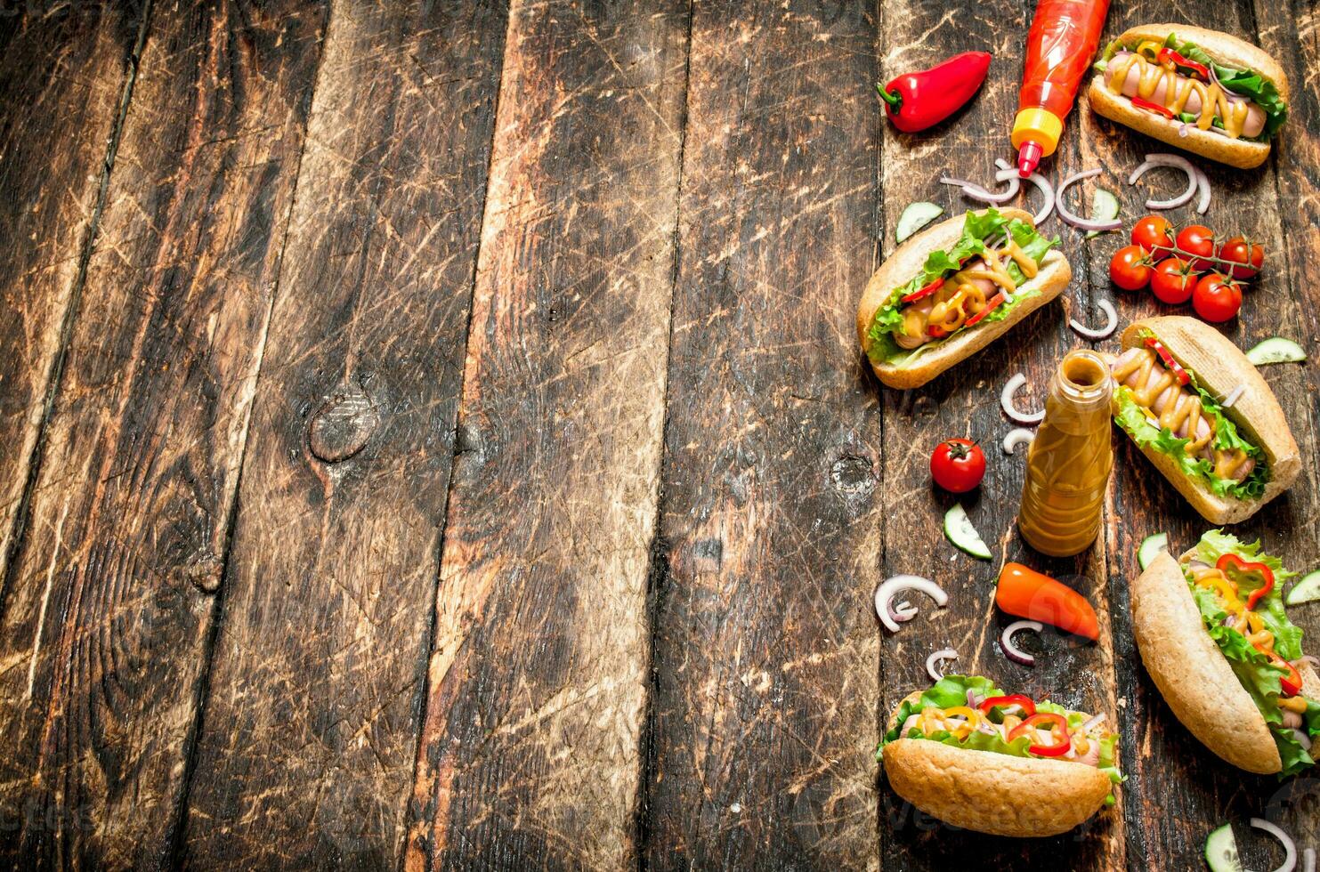Street food. Hot dogs with mustard, hot sauce , onion and greens. photo