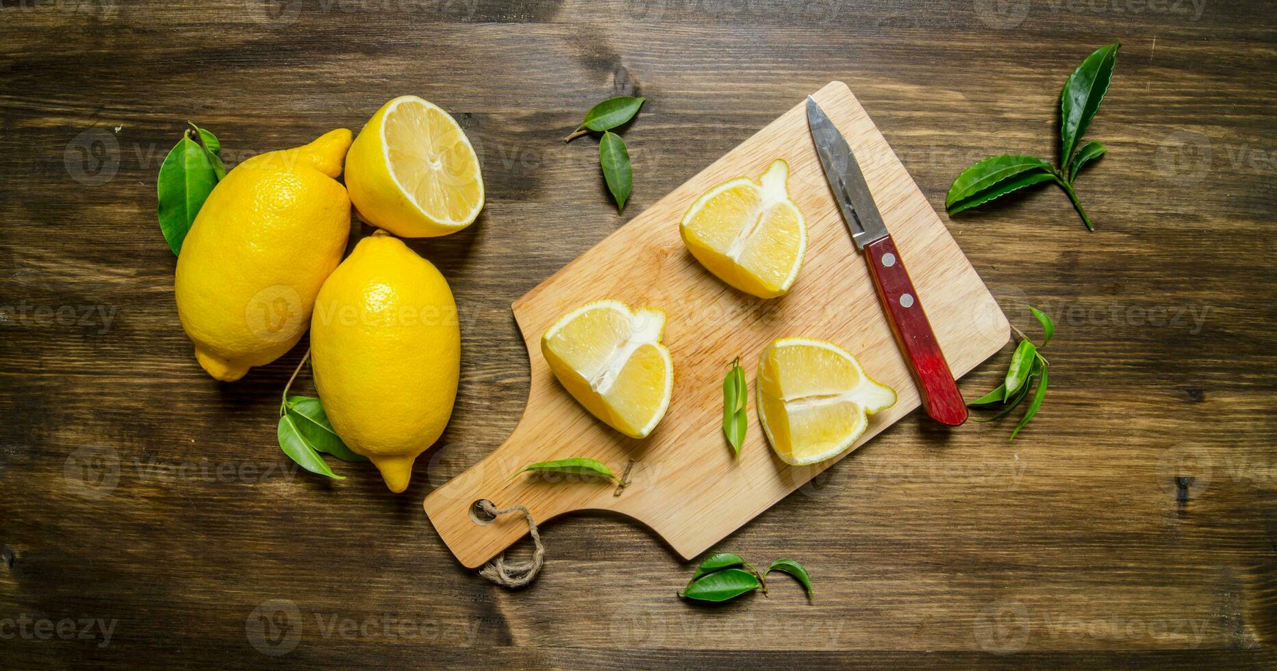 Sliced lemon on the board with leaves. photo