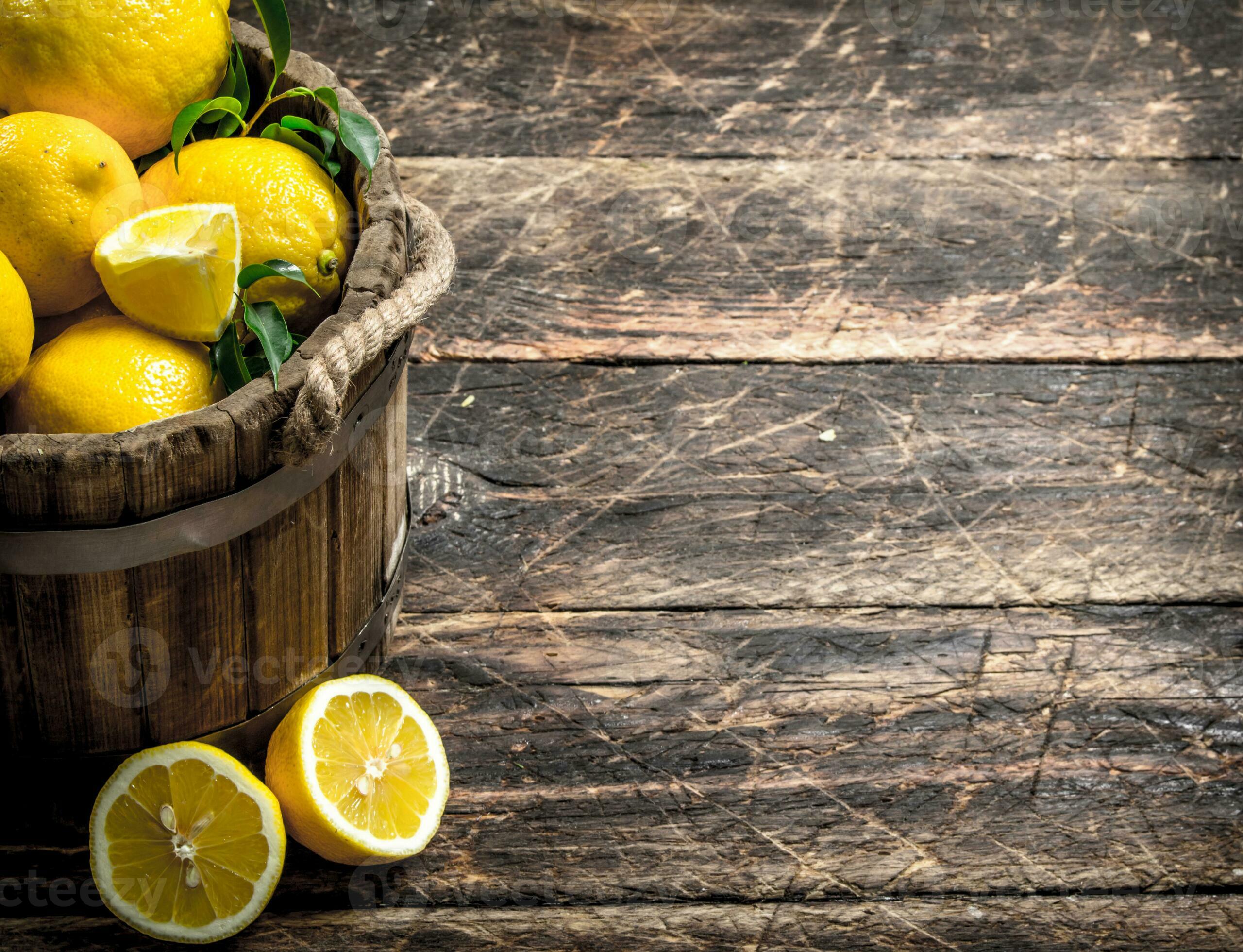 Fresh lemons in a wooden bucket. 32024236 Stock Photo at Vecteezy