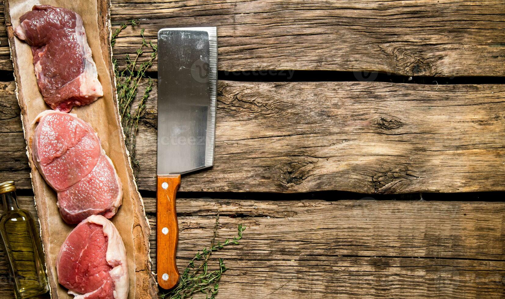 Fresh steak from raw meat and spices and chopping knife. photo