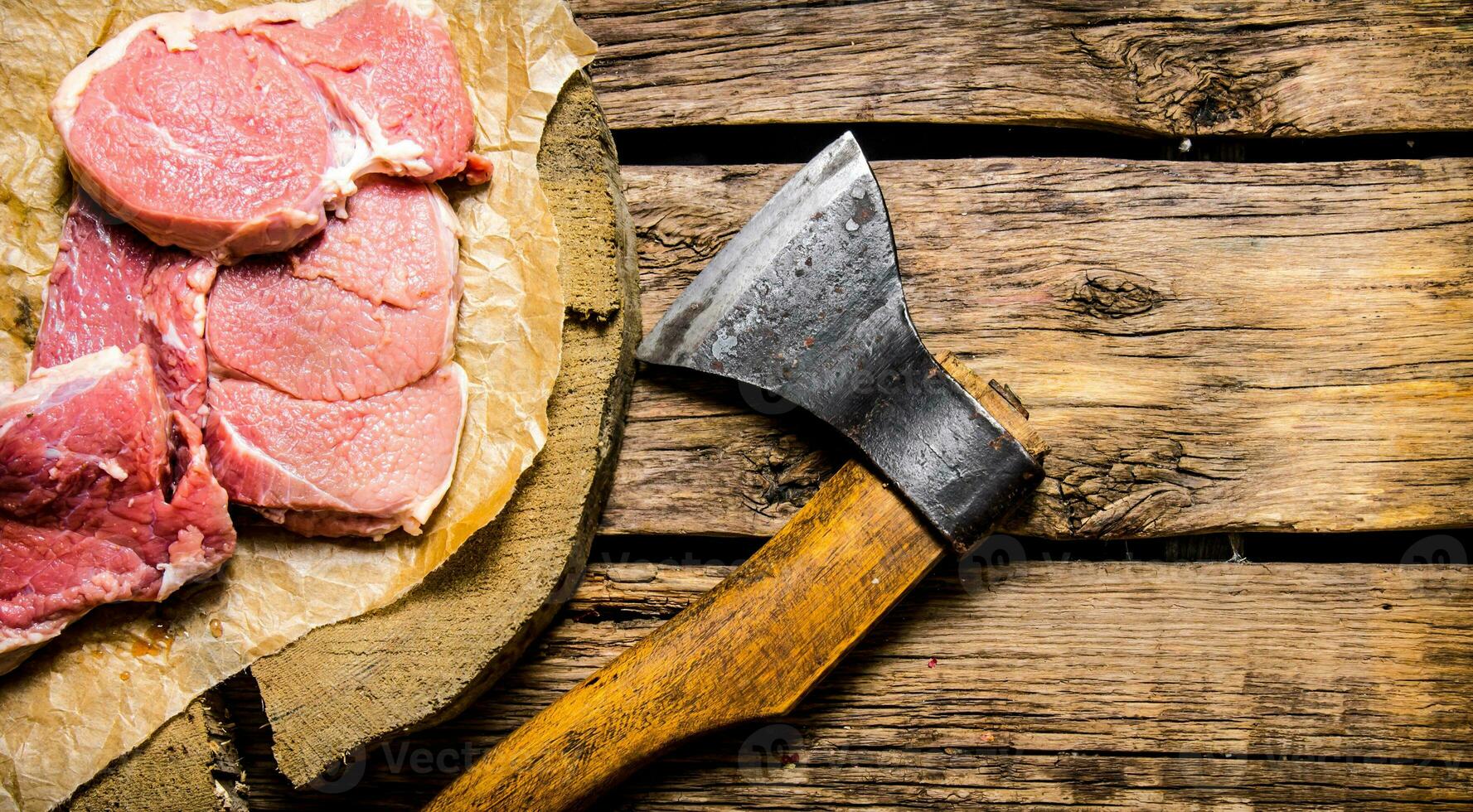 Fresh raw minced meat with an axe. photo