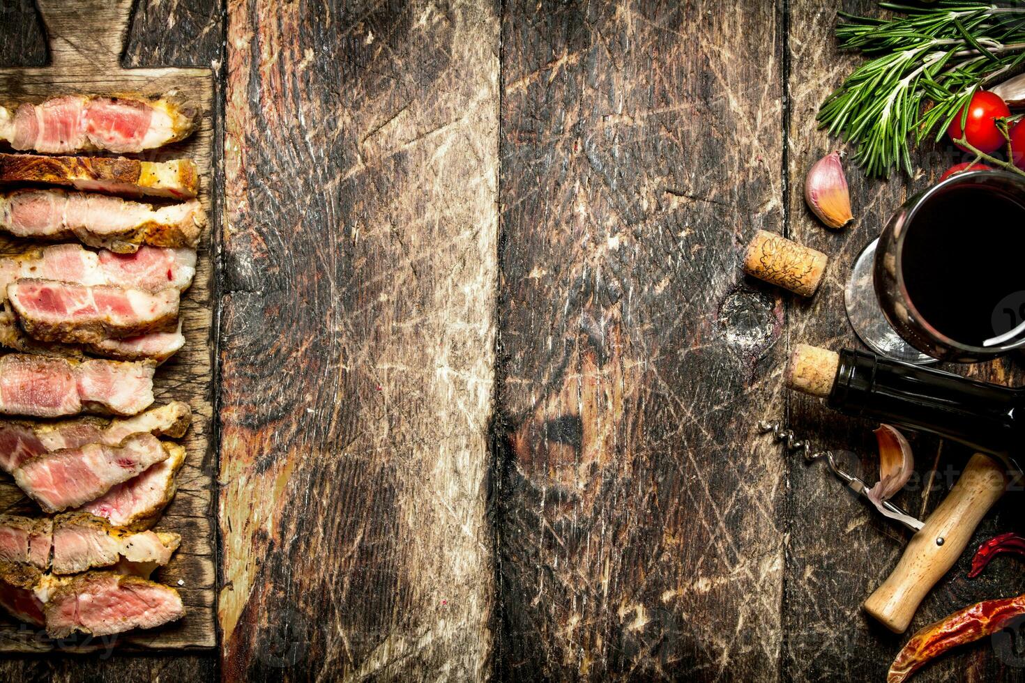 Meat grill. Pieces of pork grilled with spices and red wine. On the old wooden table. photo
