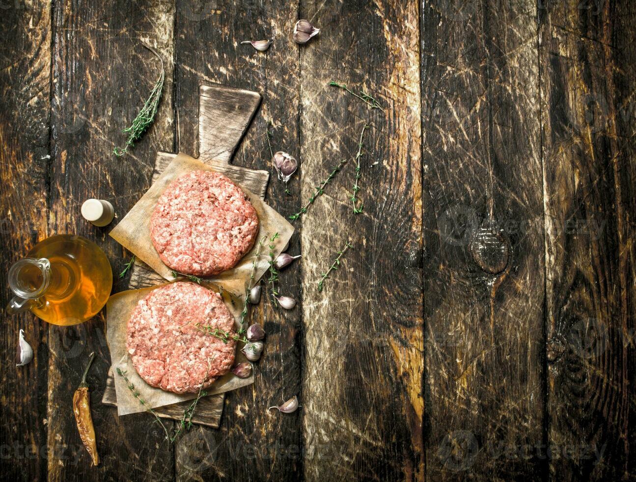 Raw burger from beef with spices and olive oil. photo