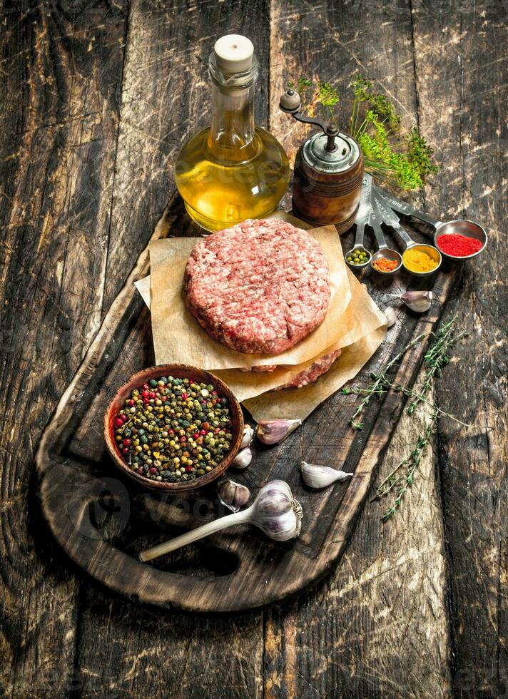 Raw burger from beef with spices and olive oil. photo