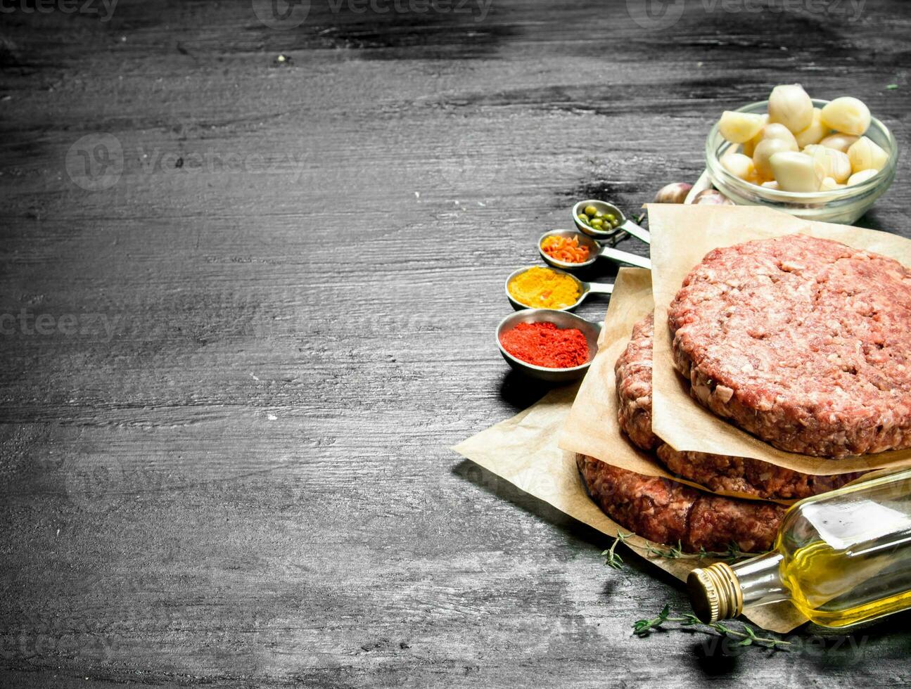 Raw burger with spices and herbs. photo