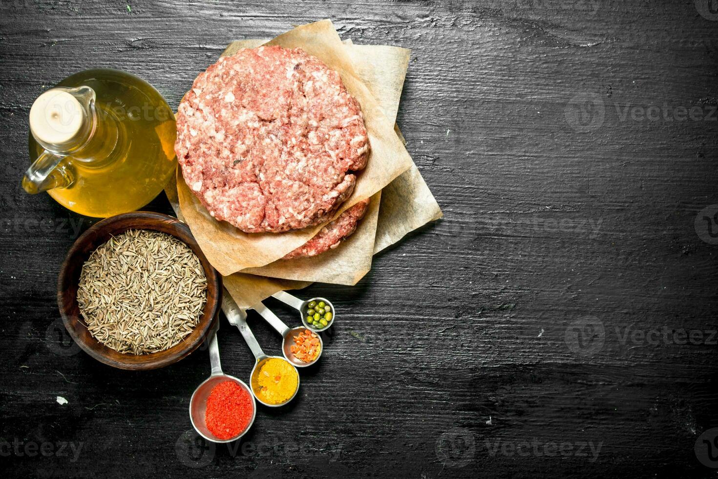 Raw burger with spices and herbs. photo