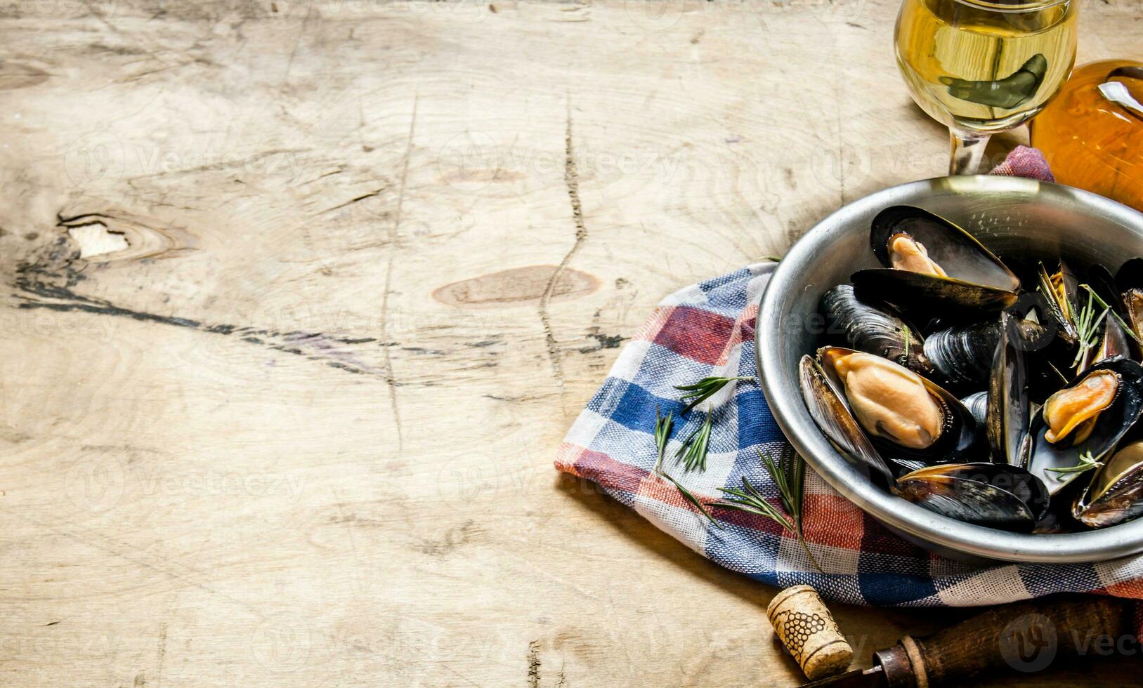 Wine with clams in a cup on the fabric. photo