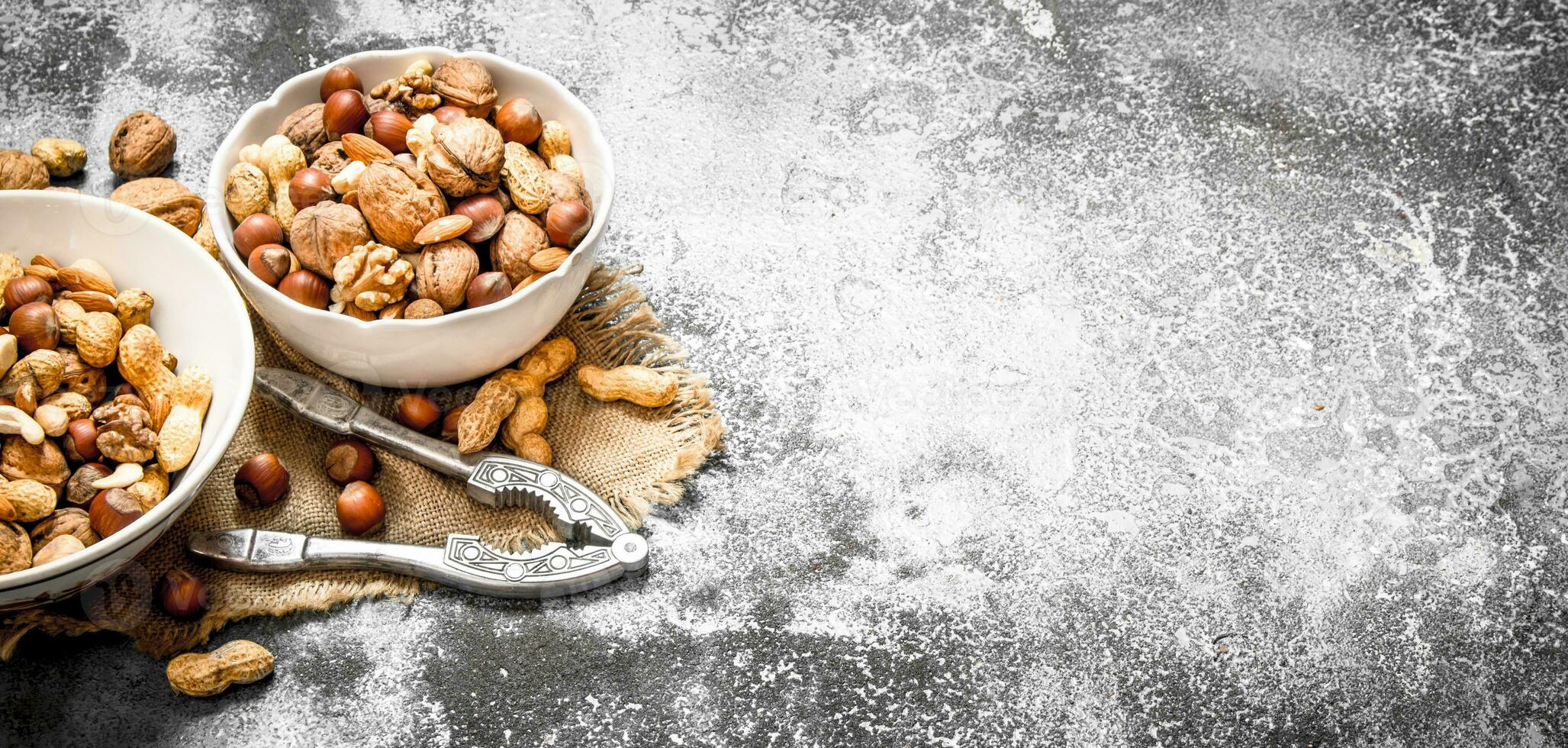 Various nuts in a bowl with a Nutcracker. photo