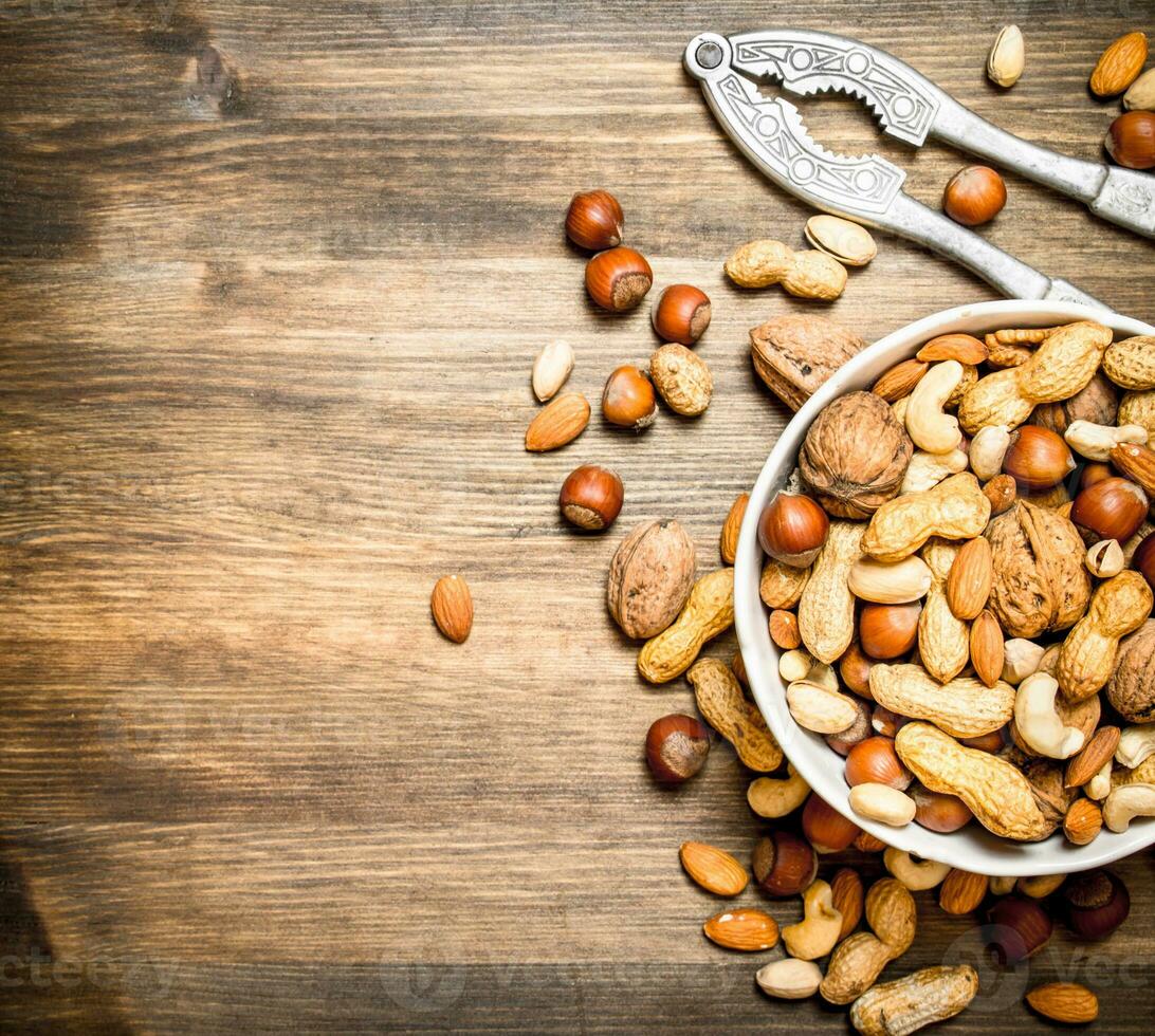 Nuts with Nutcracker in a bowl. photo