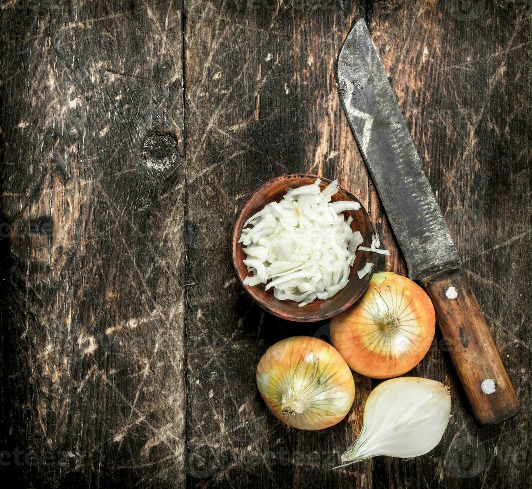Sliced onions in a wooden bowl. photo