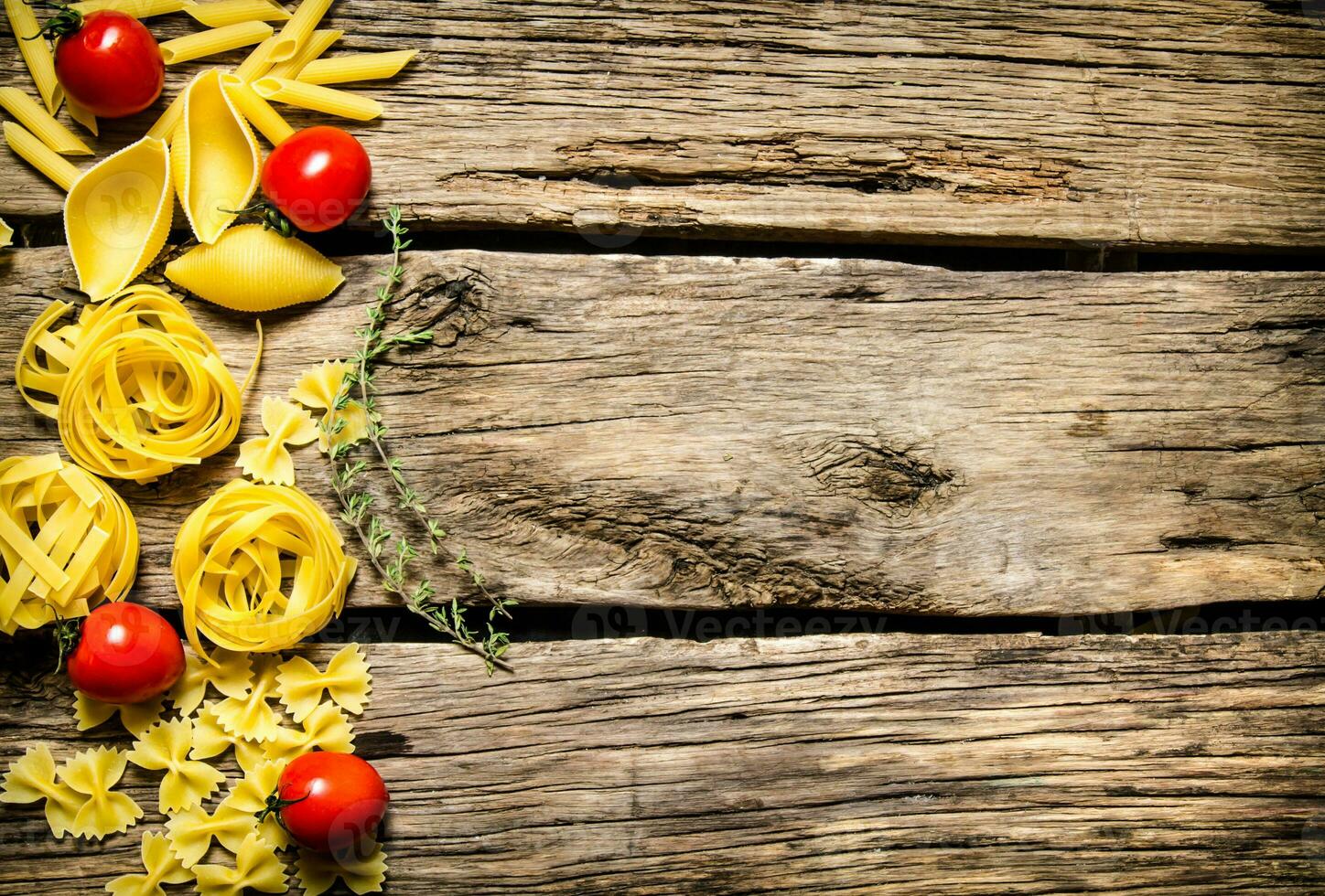 Dry pasta with cherry tomatoes and herb. photo