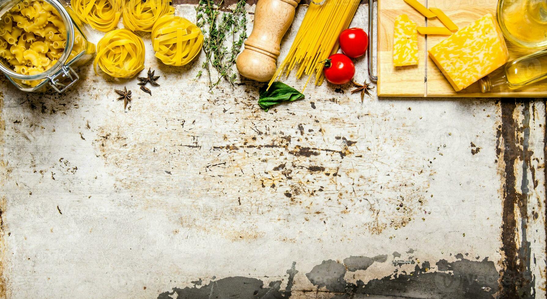 Pasta background. Dry pasta with vegetables, mushrooms, cheese and herbs. photo