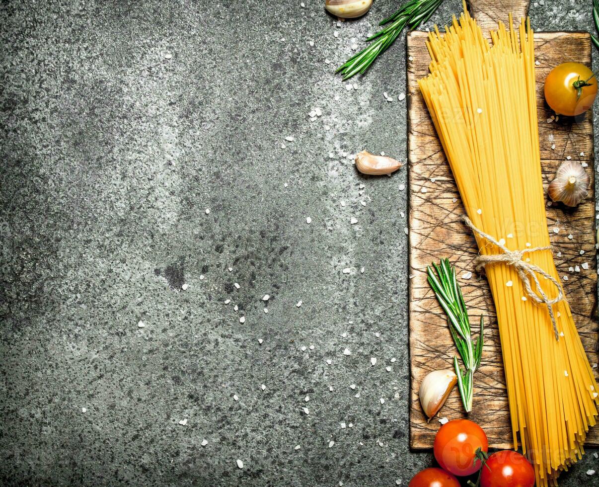 Pasta background. Spaghetti with garlic and tomatoes. photo