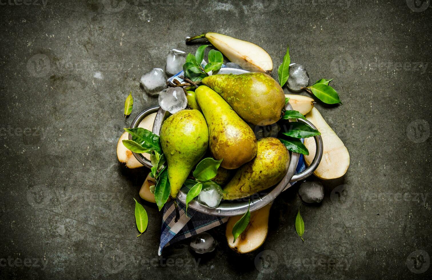 Pears in a saucepan with leaves and ice. photo