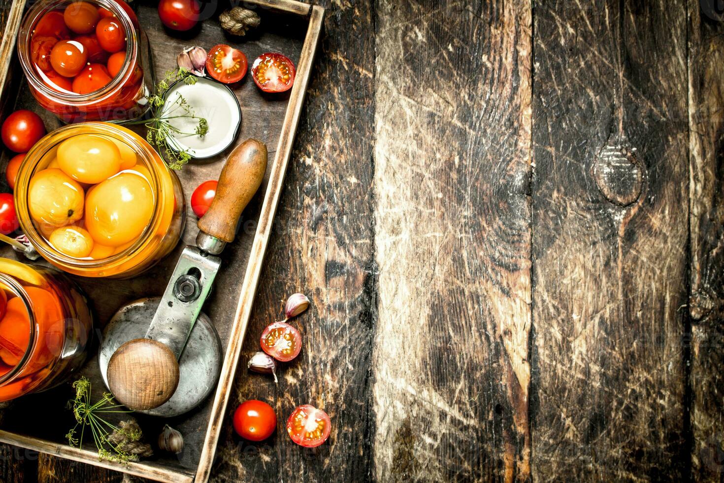 Marinated tomatoes with spices in an old tray. photo