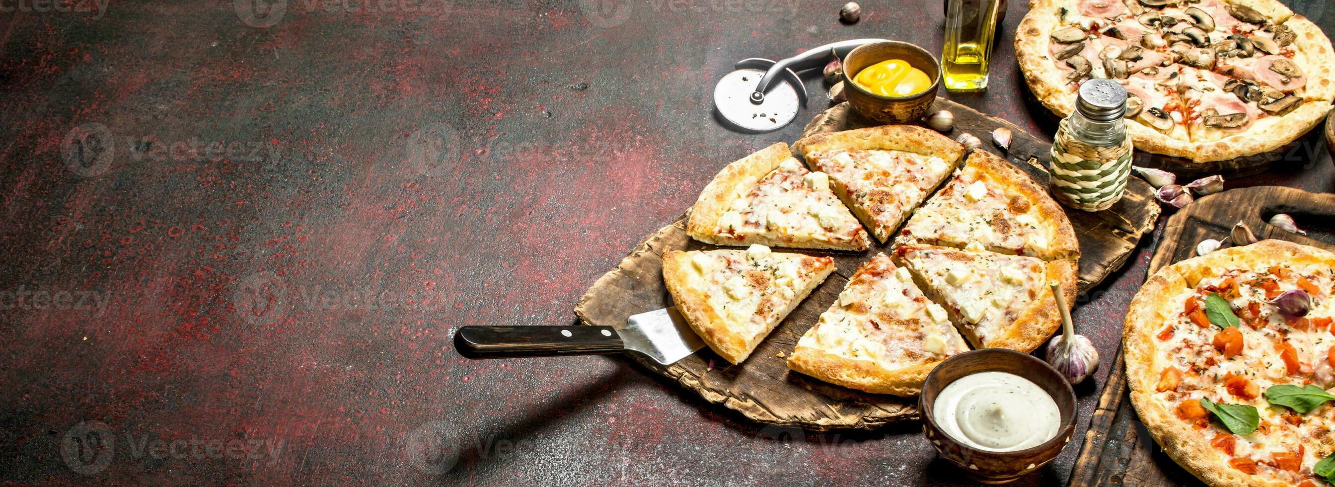 variety of pizzas with sauces. photo
