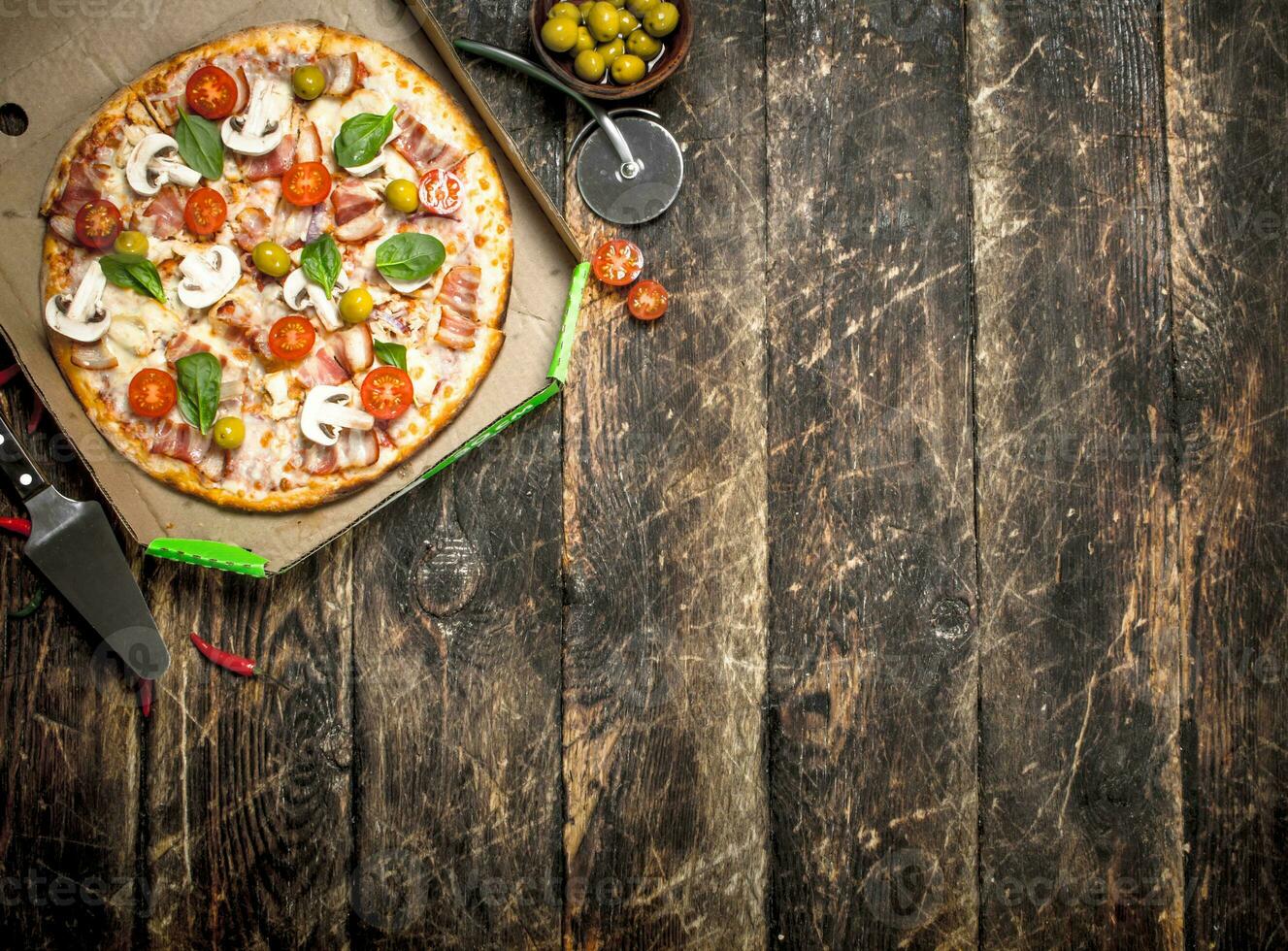 Pizza with fresh vegetables in a box. photo